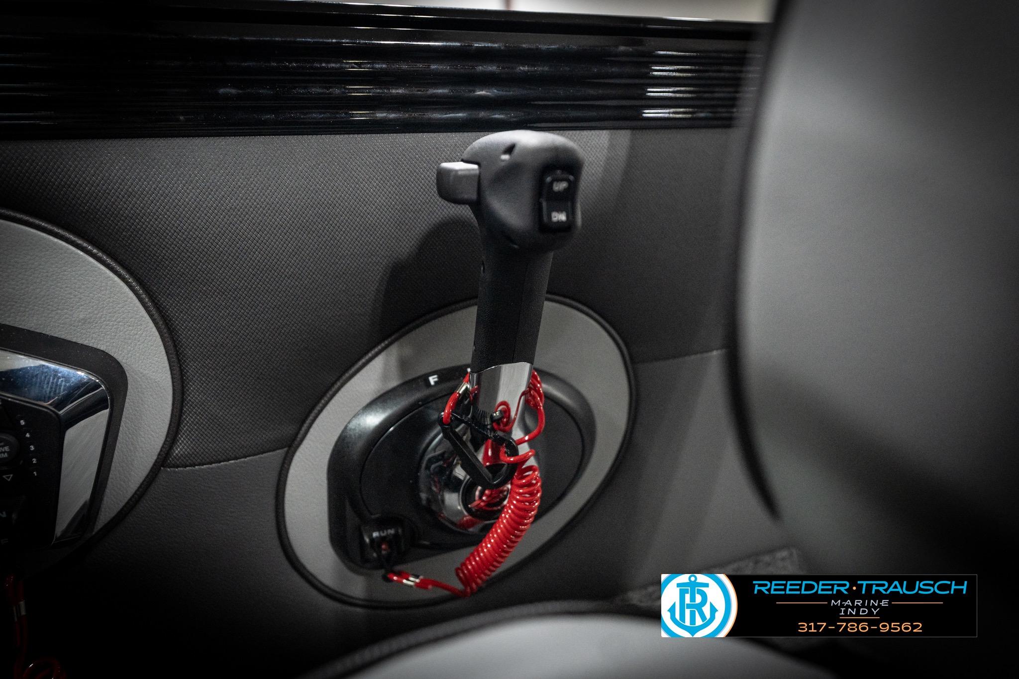 2026 Lund 2275 Baron boat throttle control with red safety cord, Reeder-Trausch Marine branding.