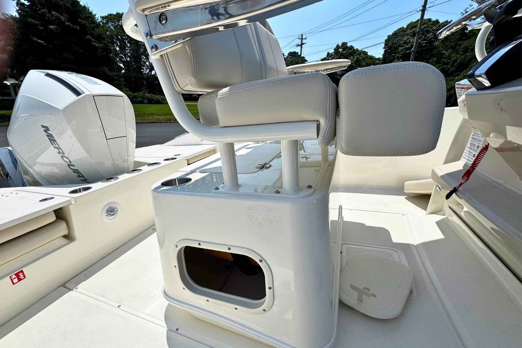 2026 Boston Whaler 220 Dauntless boat interior with seating and Mercury engine.