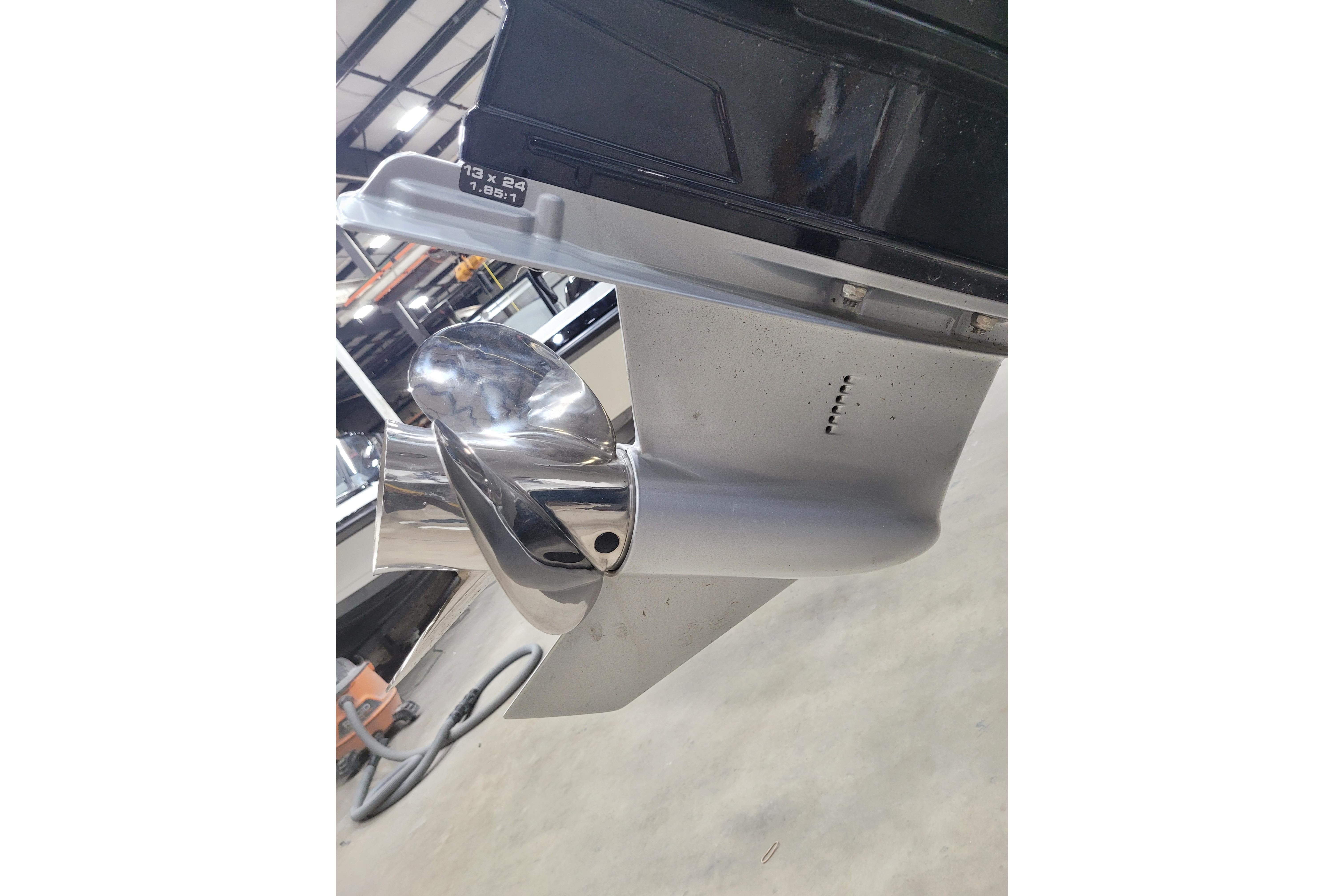 Close-up of a 2026 Tahoe 2150 boat propeller in a workshop setting.