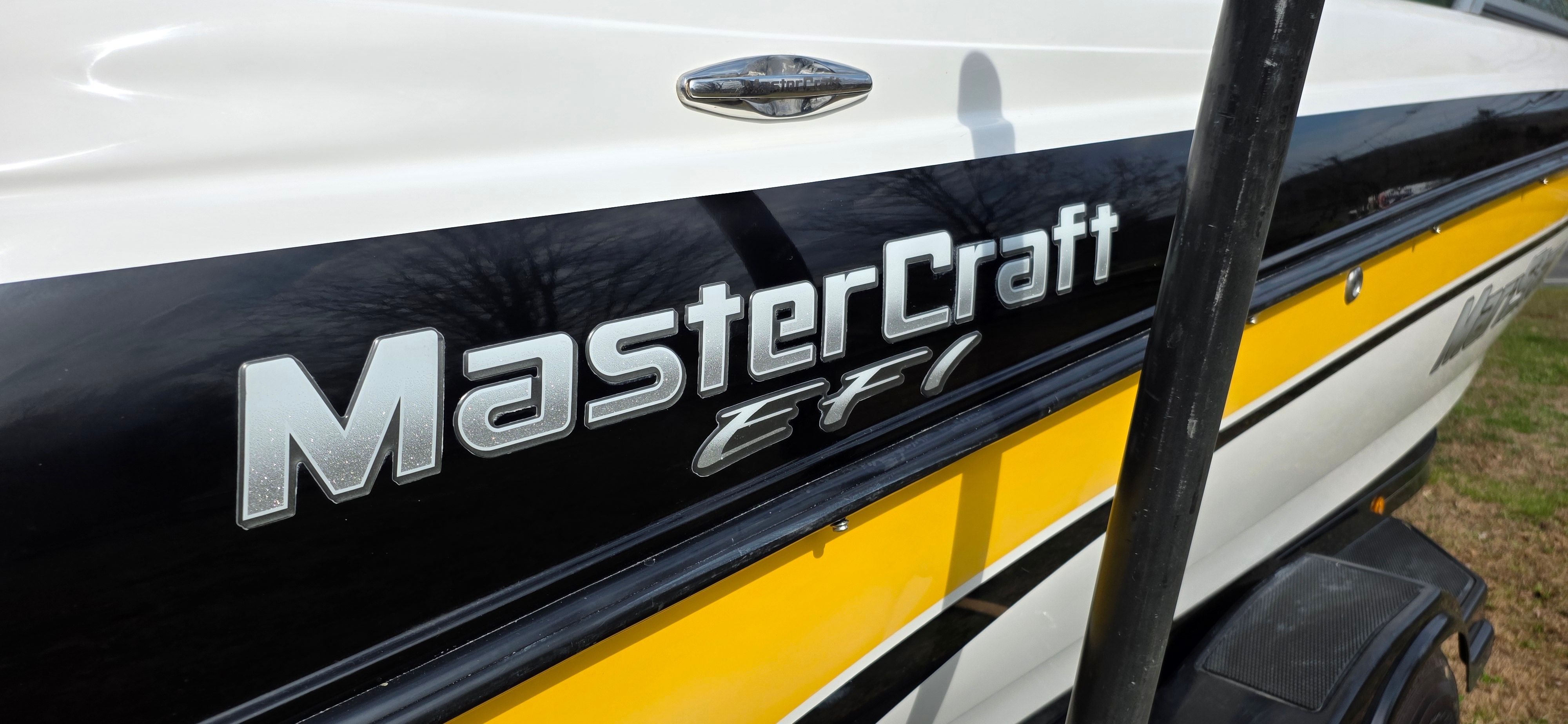 2004 MasterCraft Maristar boat with EFI logo, close-up.