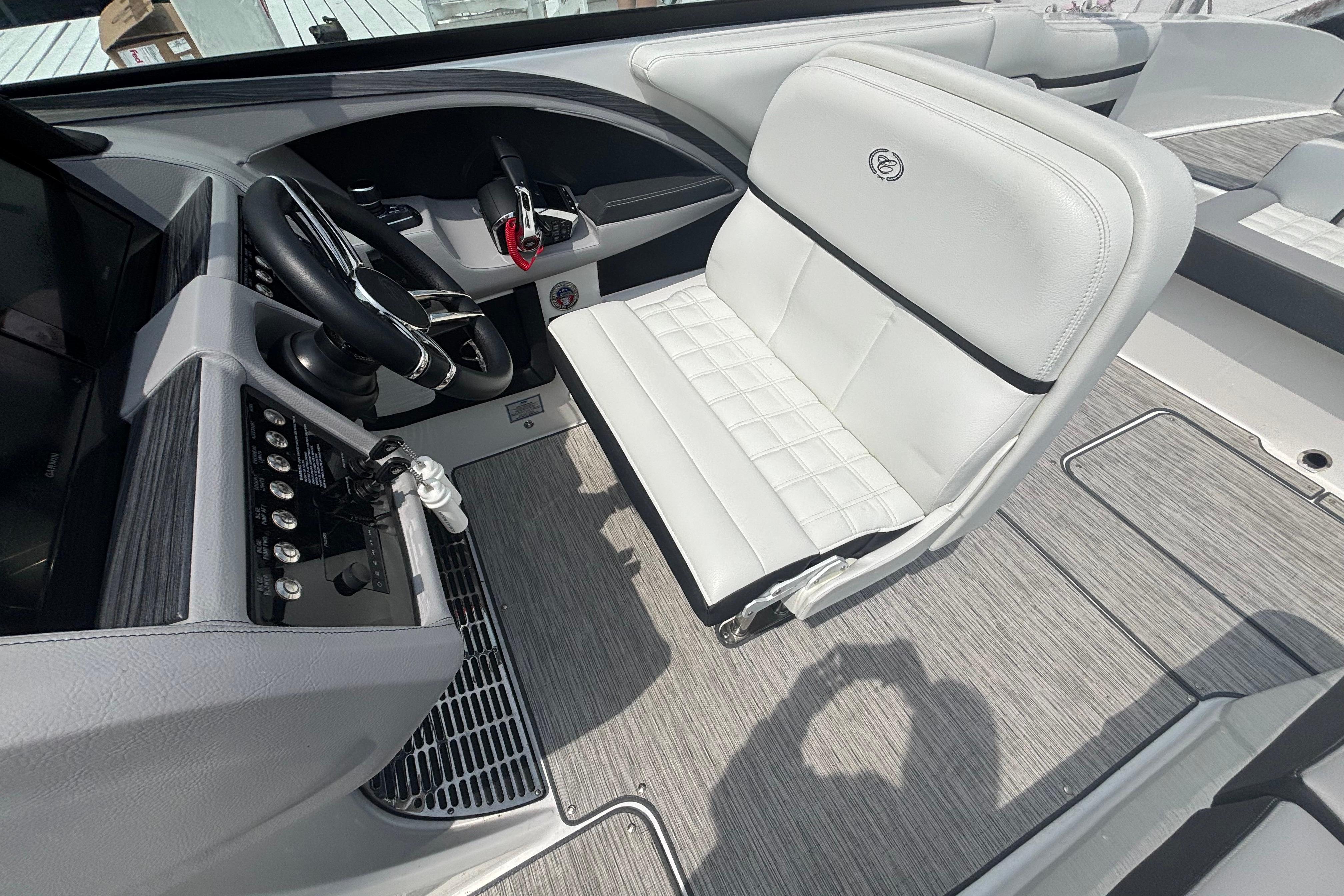 2023 Cobalt R30 boat interior with sleek steering and plush white seating.