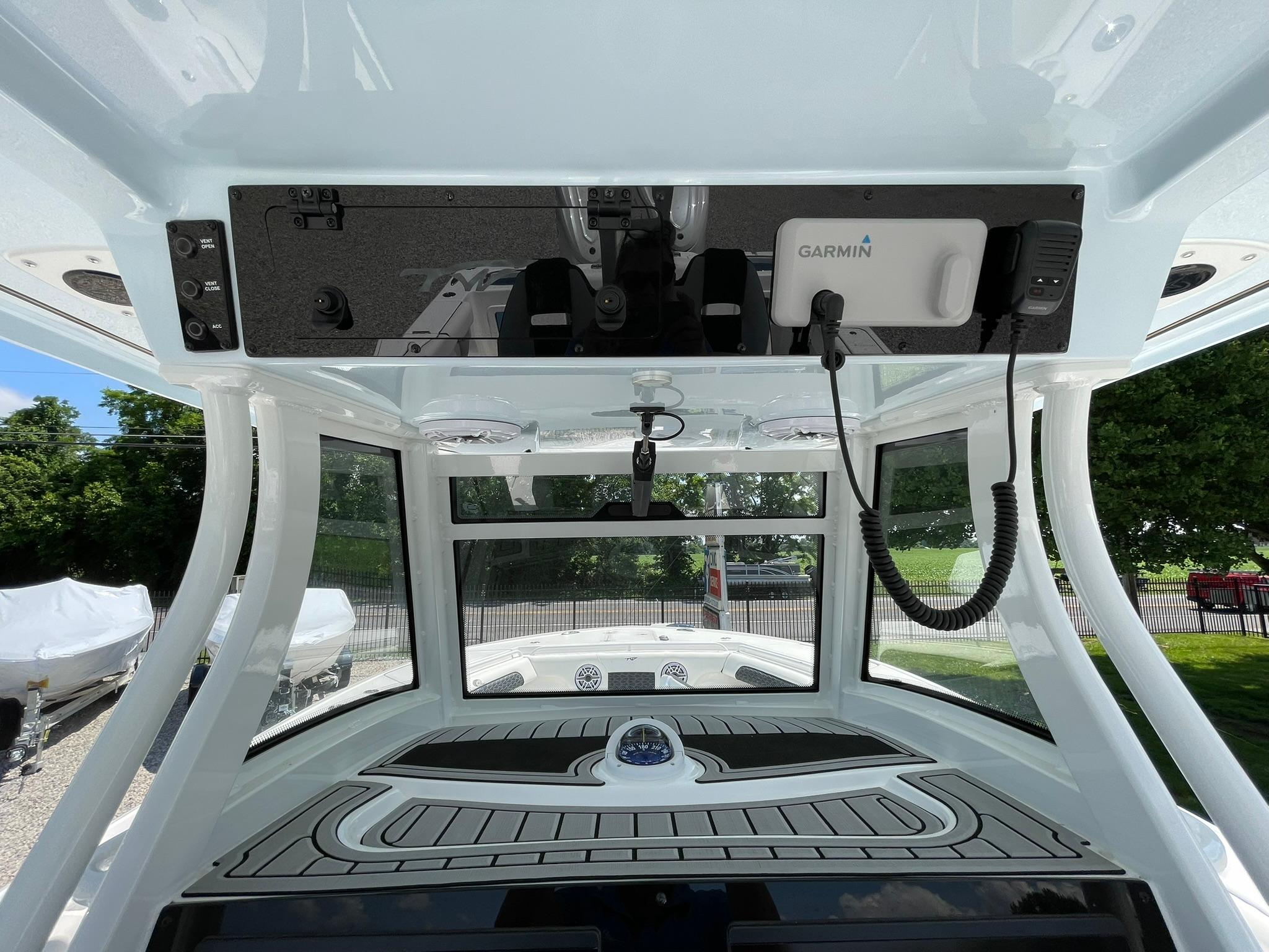 2026 Tidewater 302 CC Adventure boat interior with Garmin electronics and sleek dashboard design.