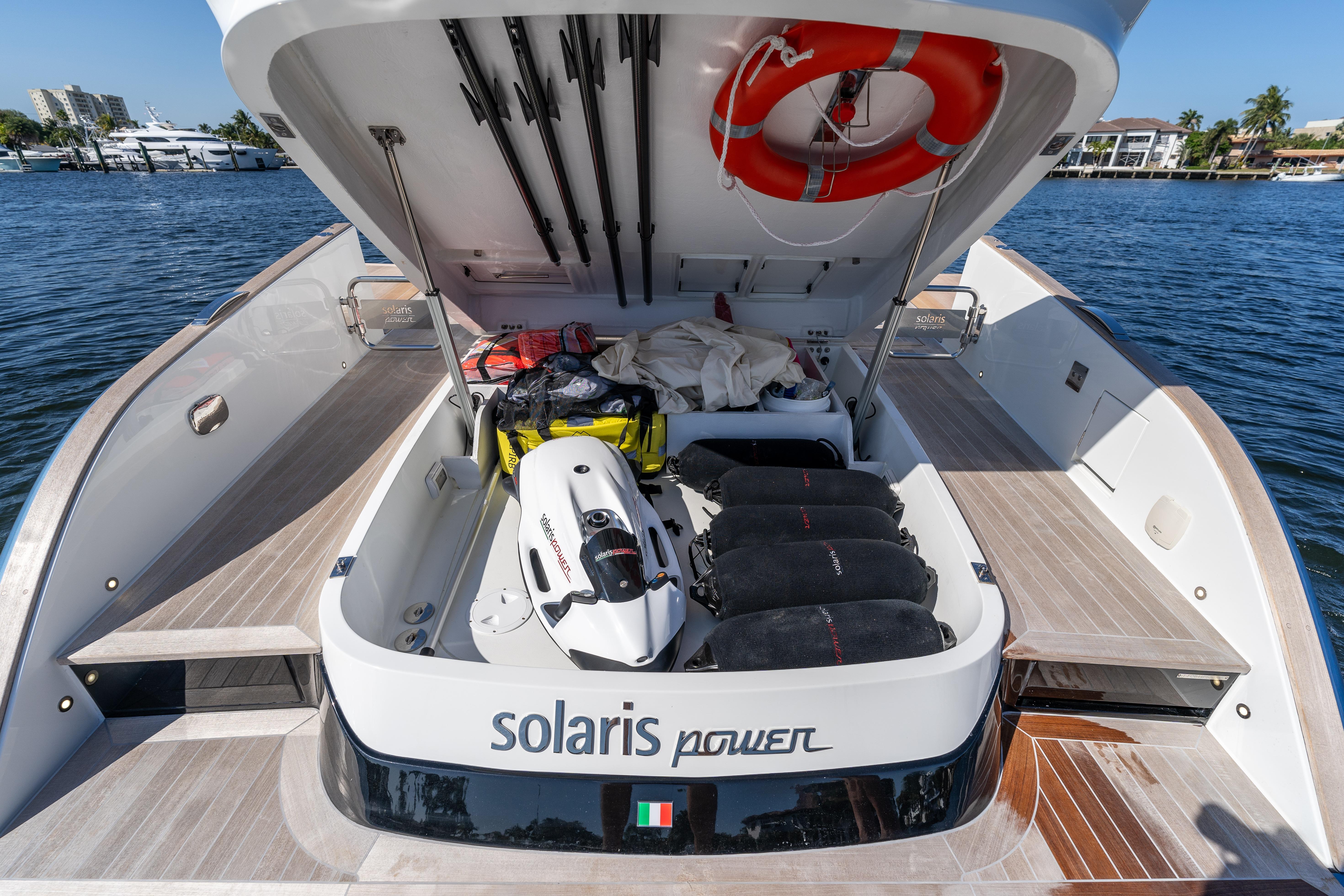 2025 Solaris Power 44 Open yacht with open storage compartment, docked by the water.