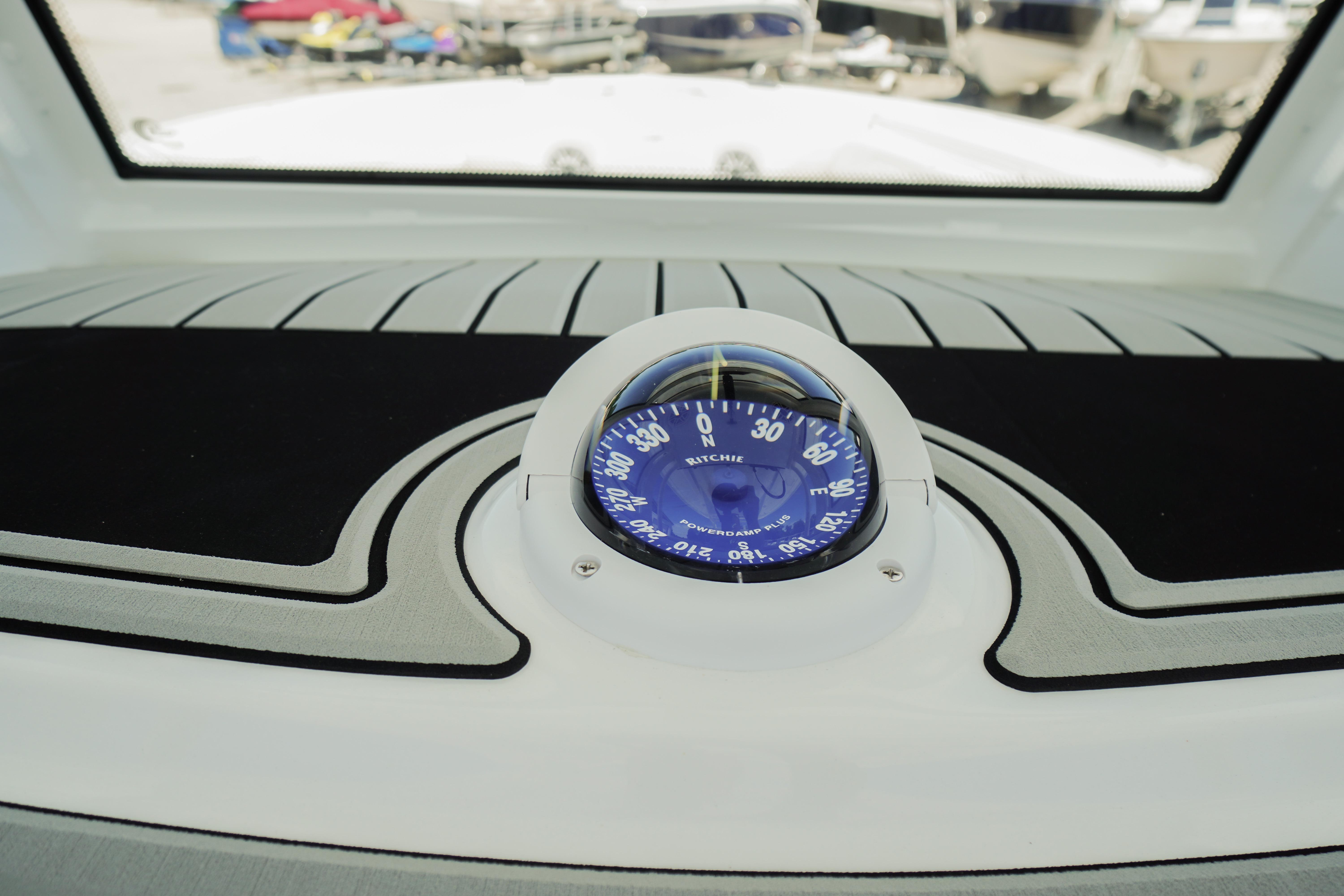 Compass on 2026 Tidewater 302 CC Adventure boat dashboard, featuring sleek design and navigation tools.