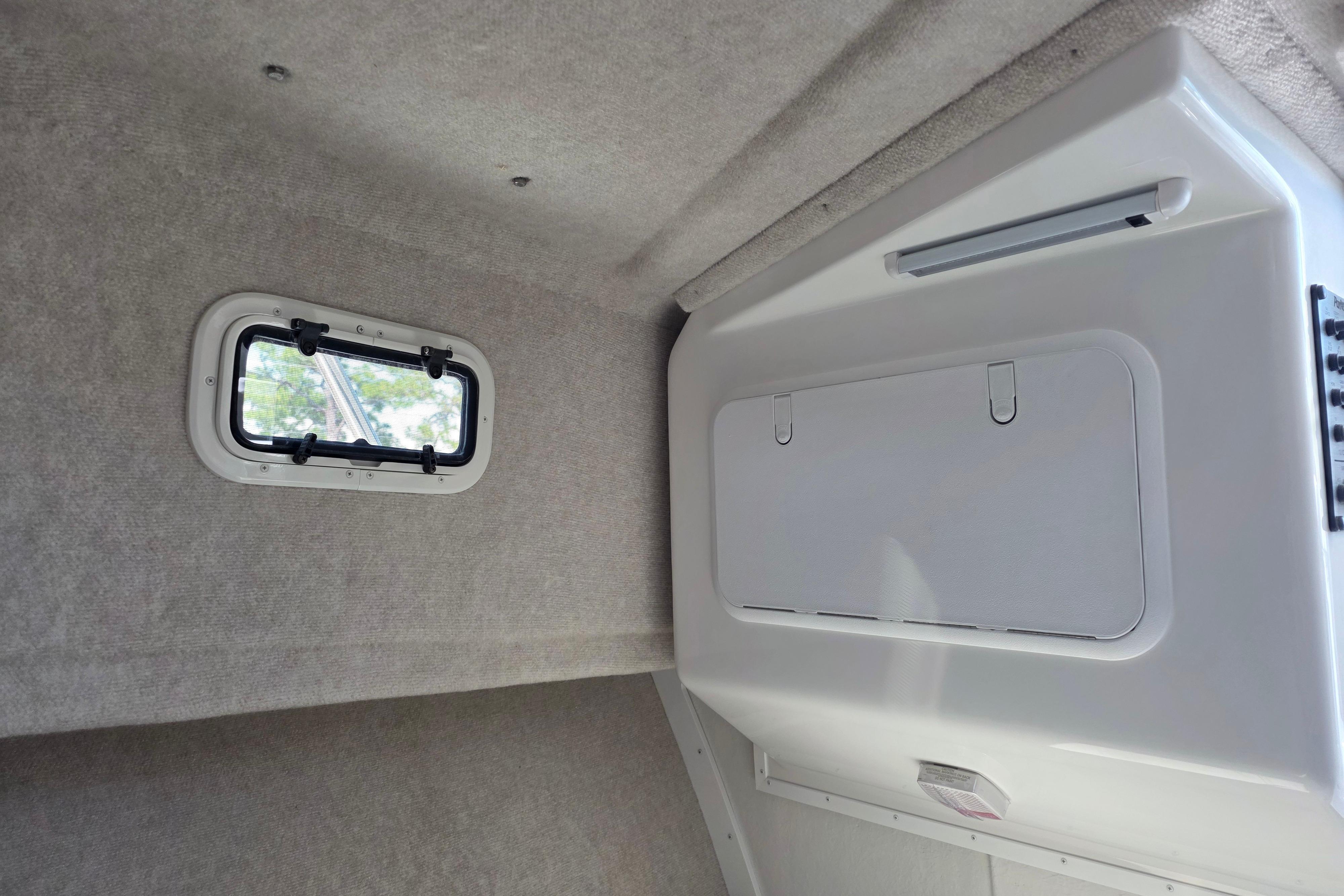 Interior cabin of 2026 Parker 287 Explorer boat with window and storage compartment.