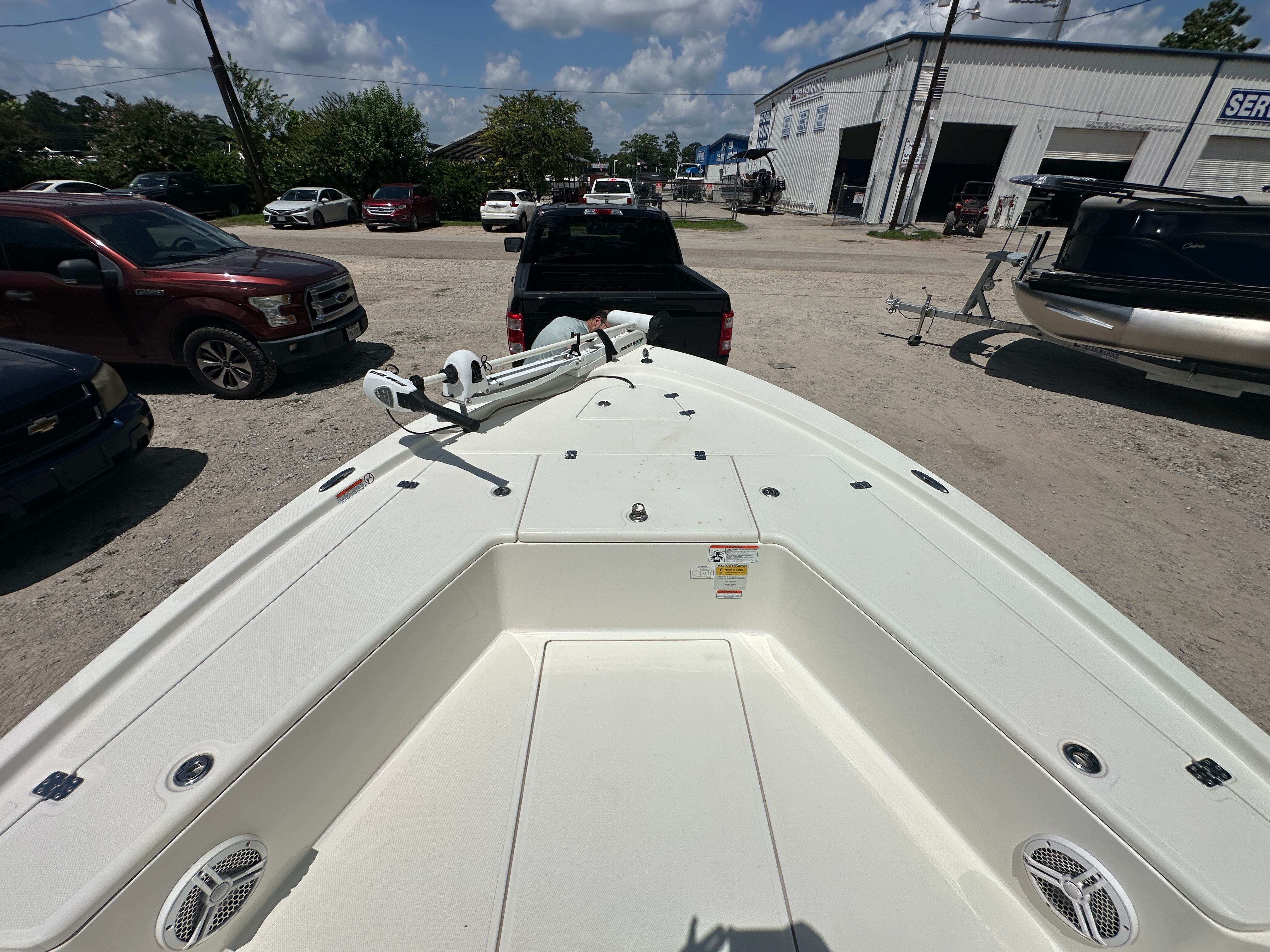 2014 Mako 21 LTS boat on a parking lot with cars.