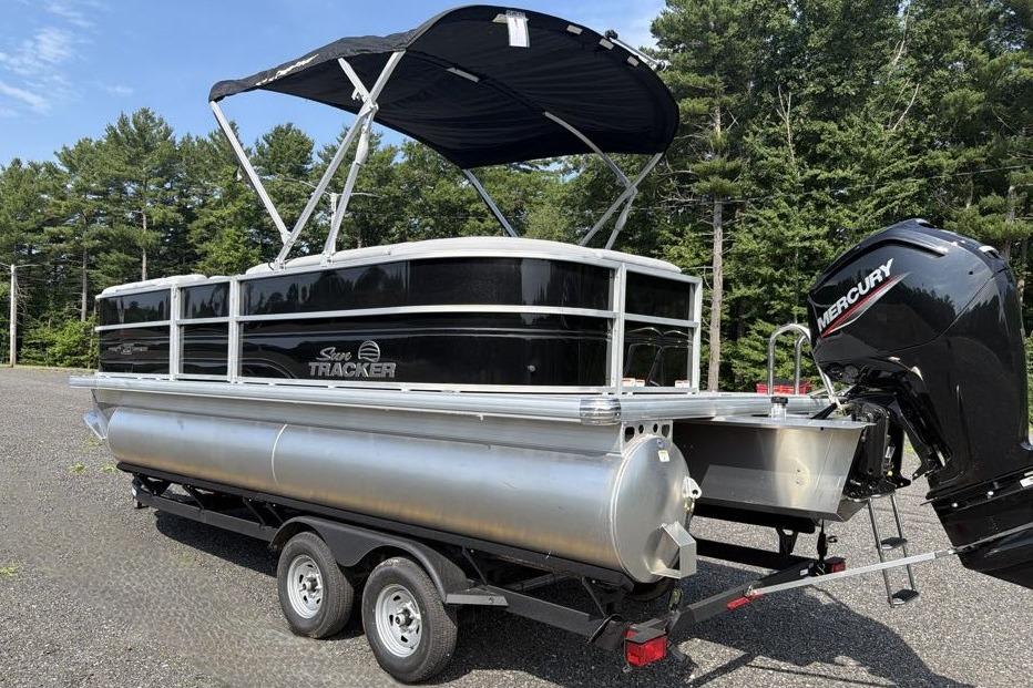 2026 Sun Tracker Party Barge 20 DLX pontoon boat with Mercury engine on trailer.