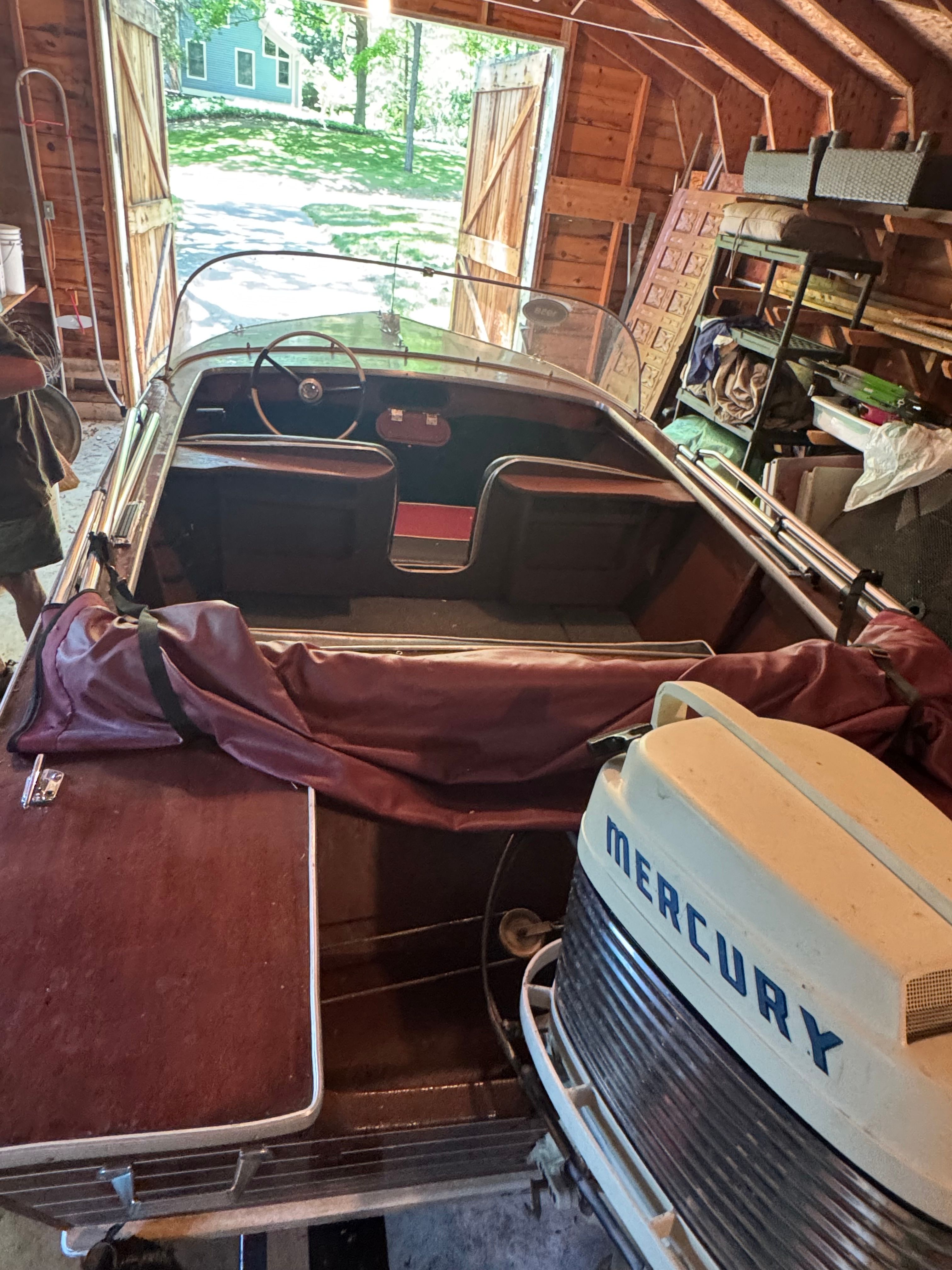 1958 Classic Sportcraft Runabout with Mercury engine in a garage.
