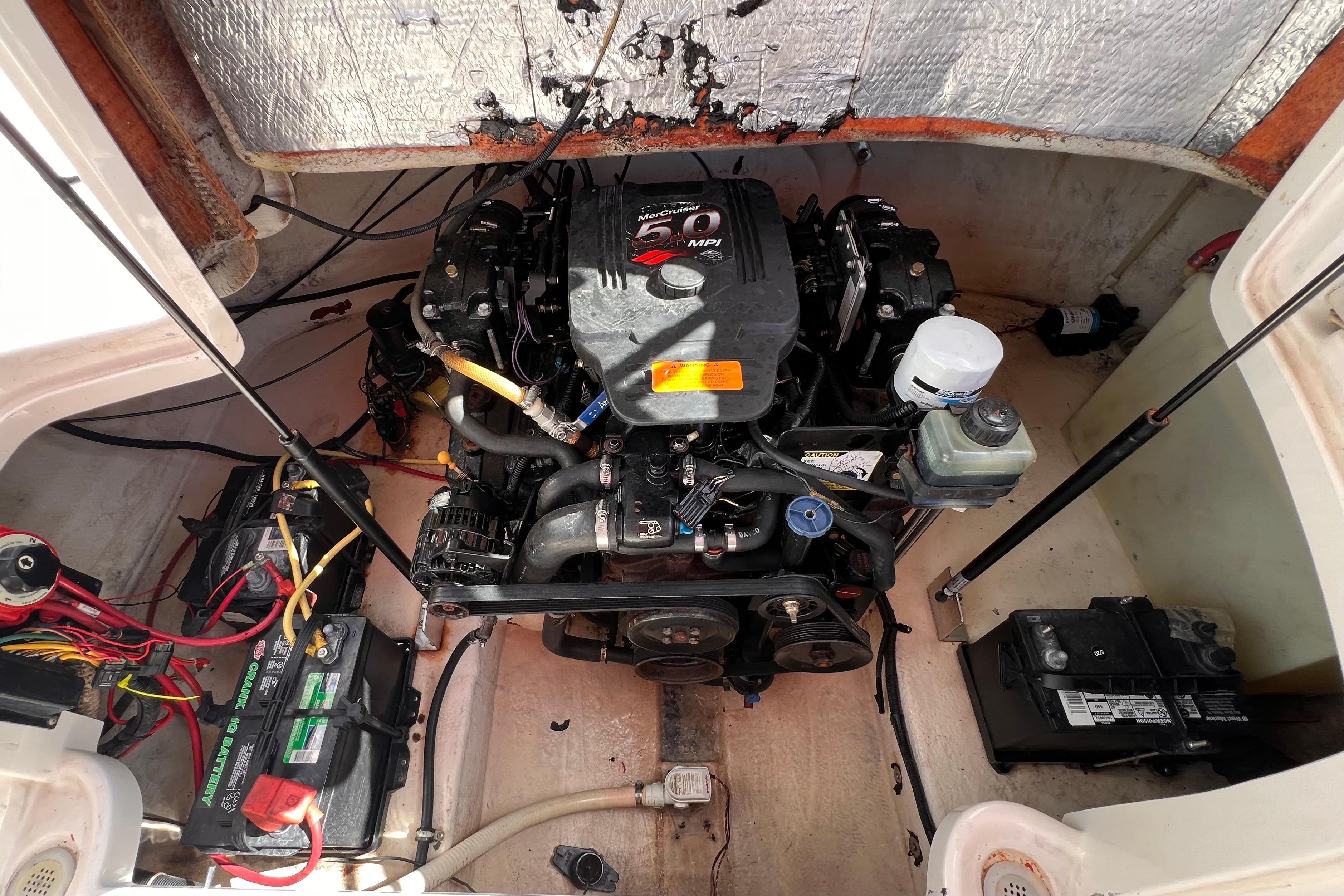 Engine compartment of a 2002 Chaparral 232 Sunesta boat with MerCruiser 5.0 MPI engine.