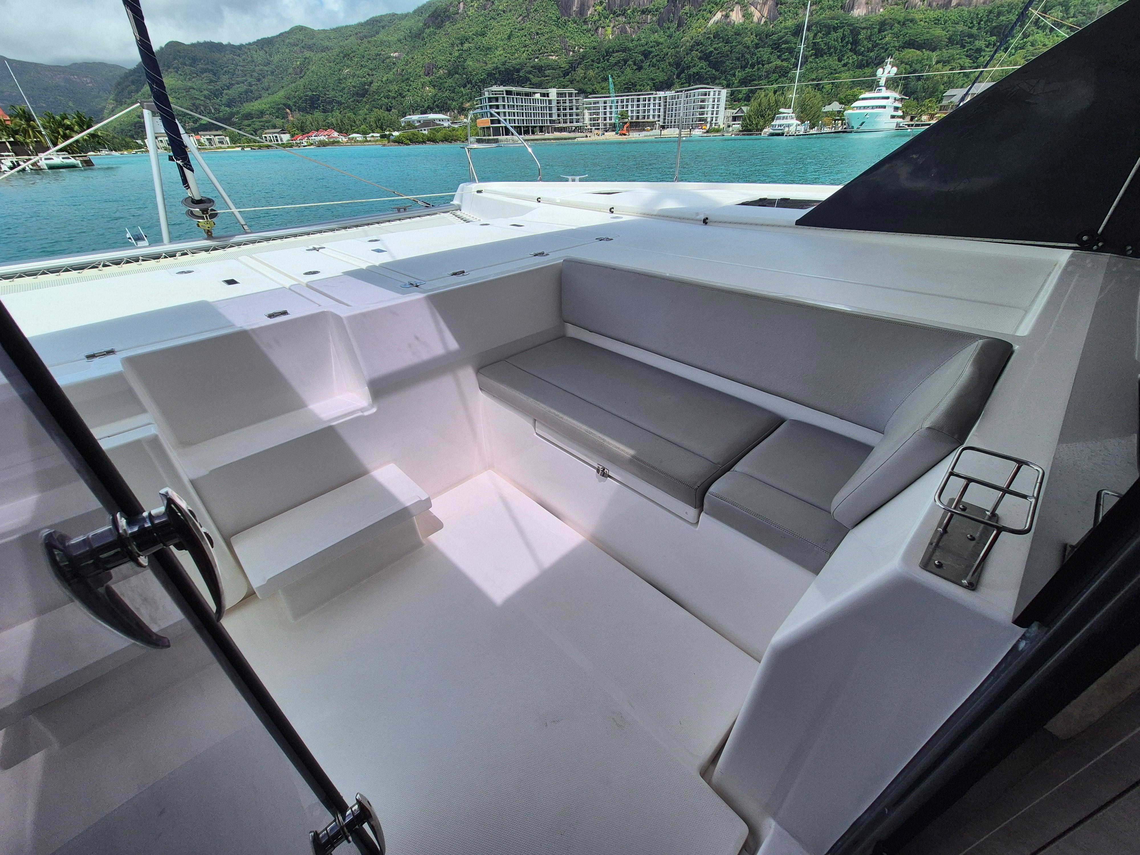 Leopard 50 yacht cockpit with seating, overlooking scenic marina and lush mountains, 2020 model.