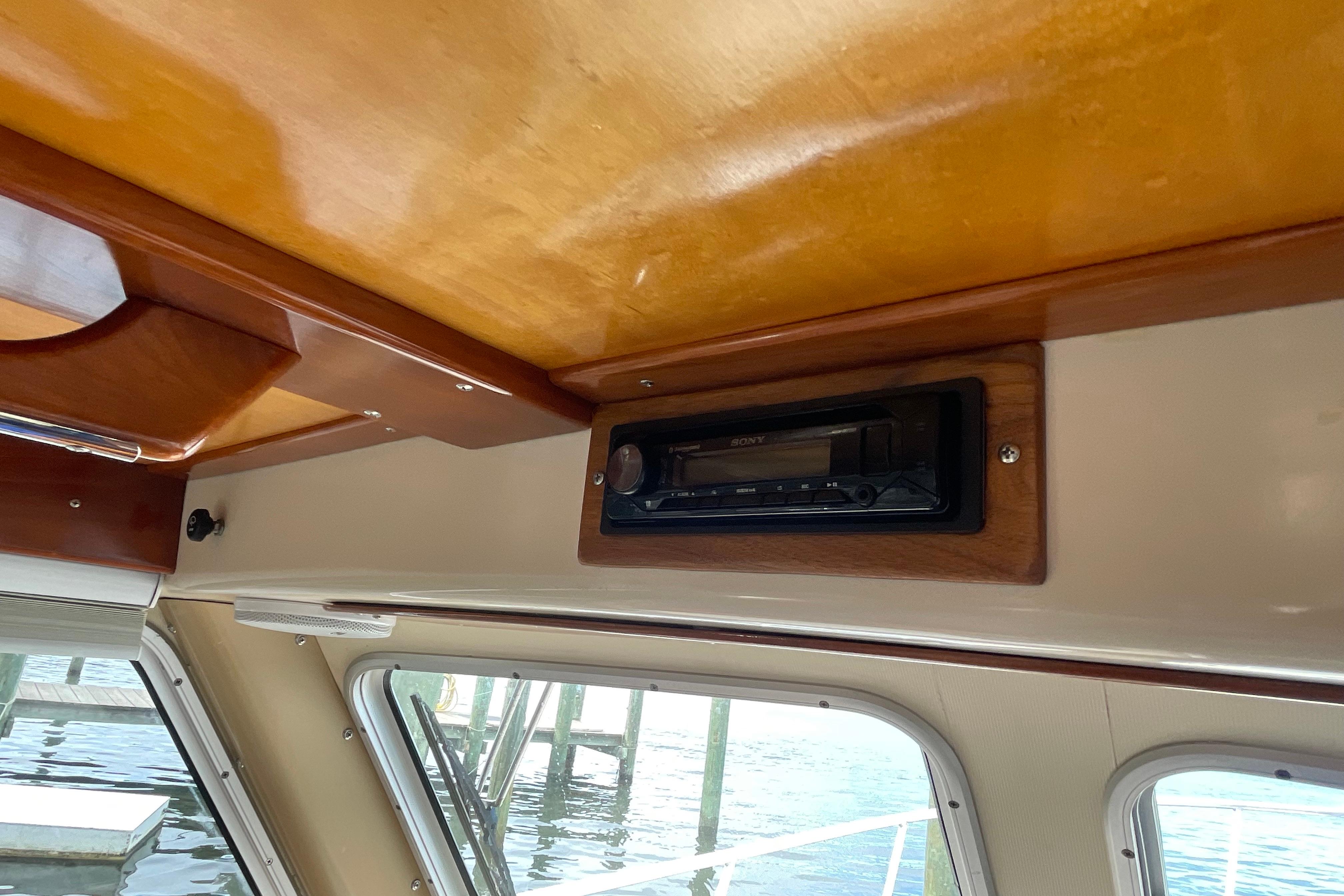 Interior of 2005 Fox Island Thirty Sedan Cruiser with wooden ceiling and built-in stereo.