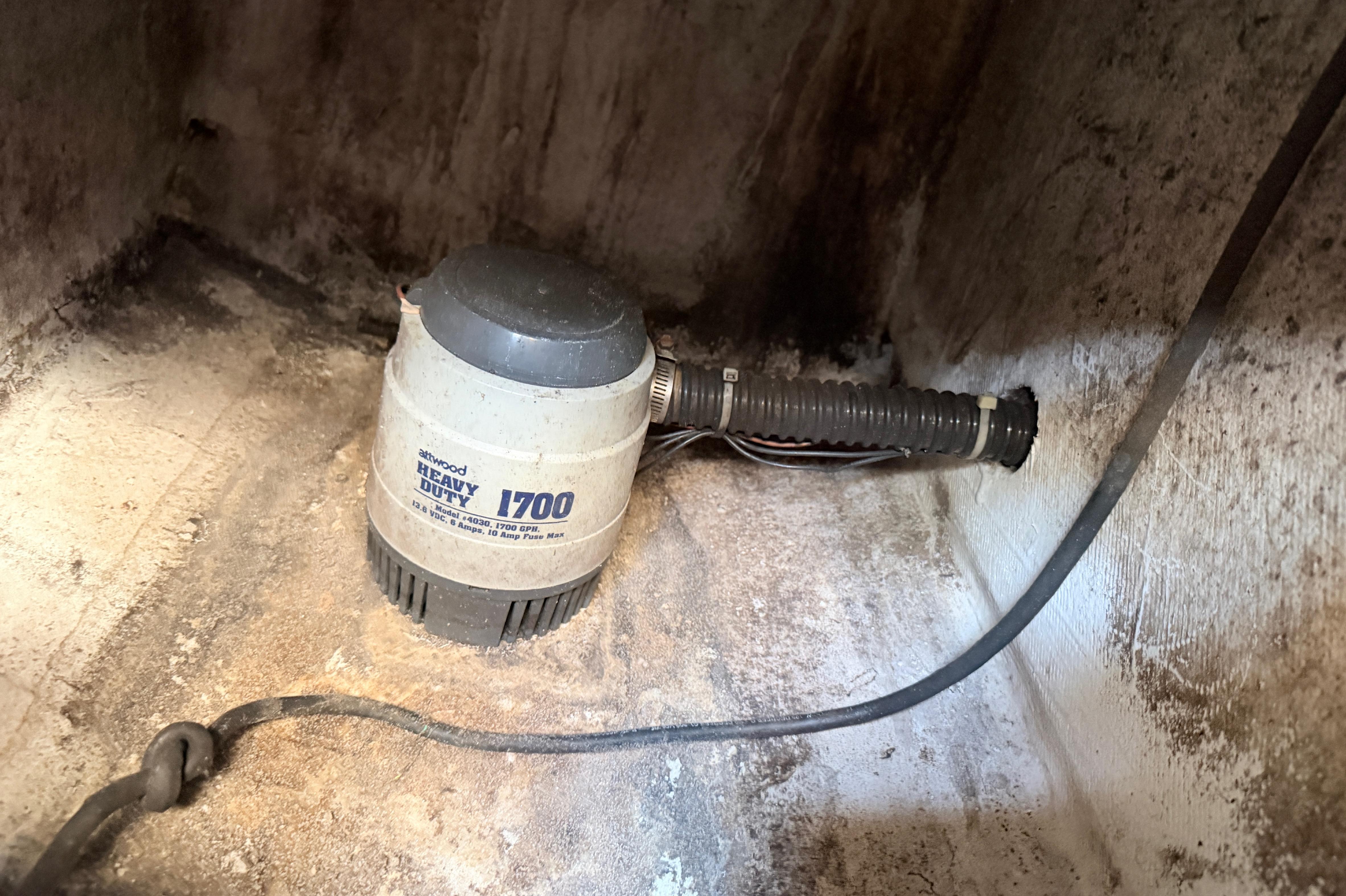 2004 Grady White 273 boat bilge pump, Atwood Heavy Duty 1700, in a weathered compartment.