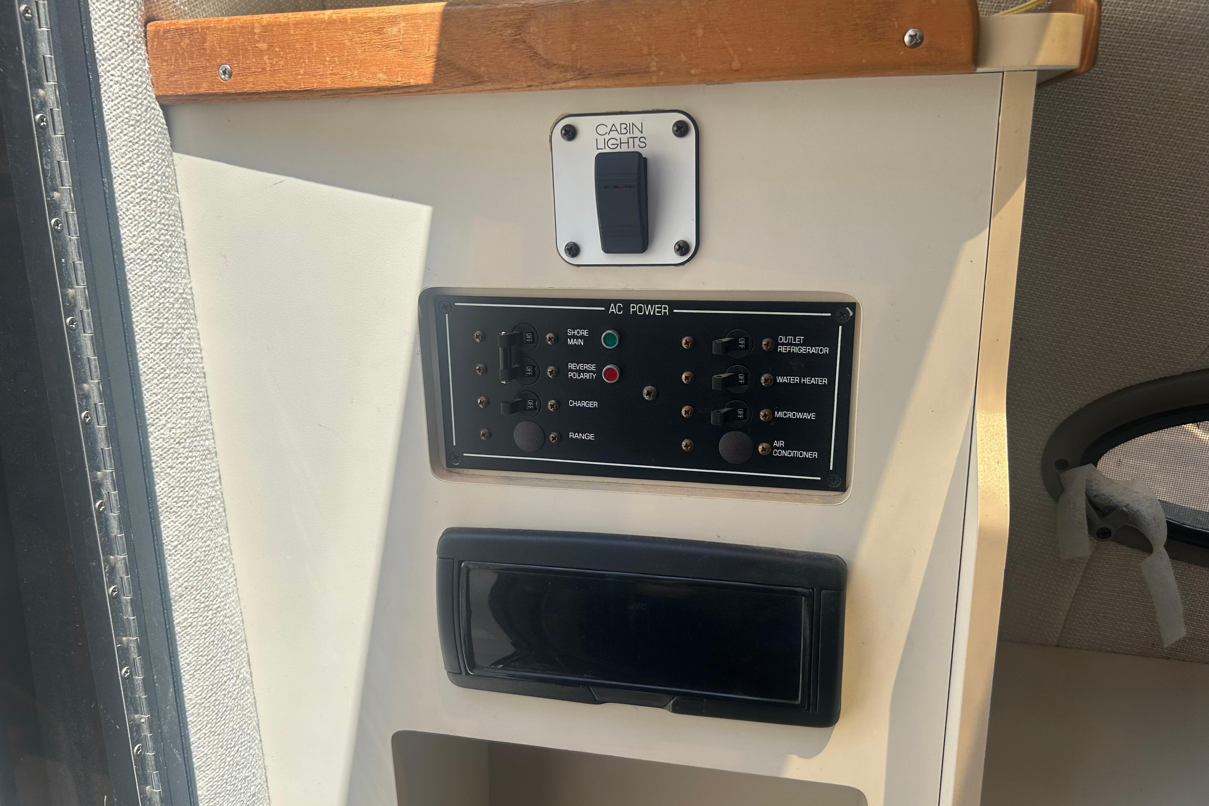 1998 Four Winns 258 Vista cabin control panel with AC power switches and cabin lights.