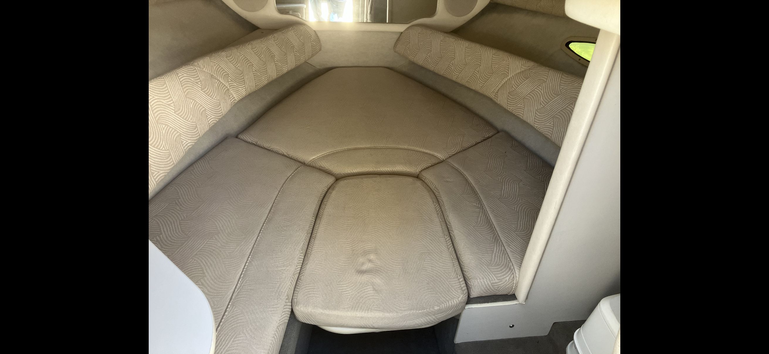 Interior of 2007 Sea Ray 215 Weekender with cushioned seating.