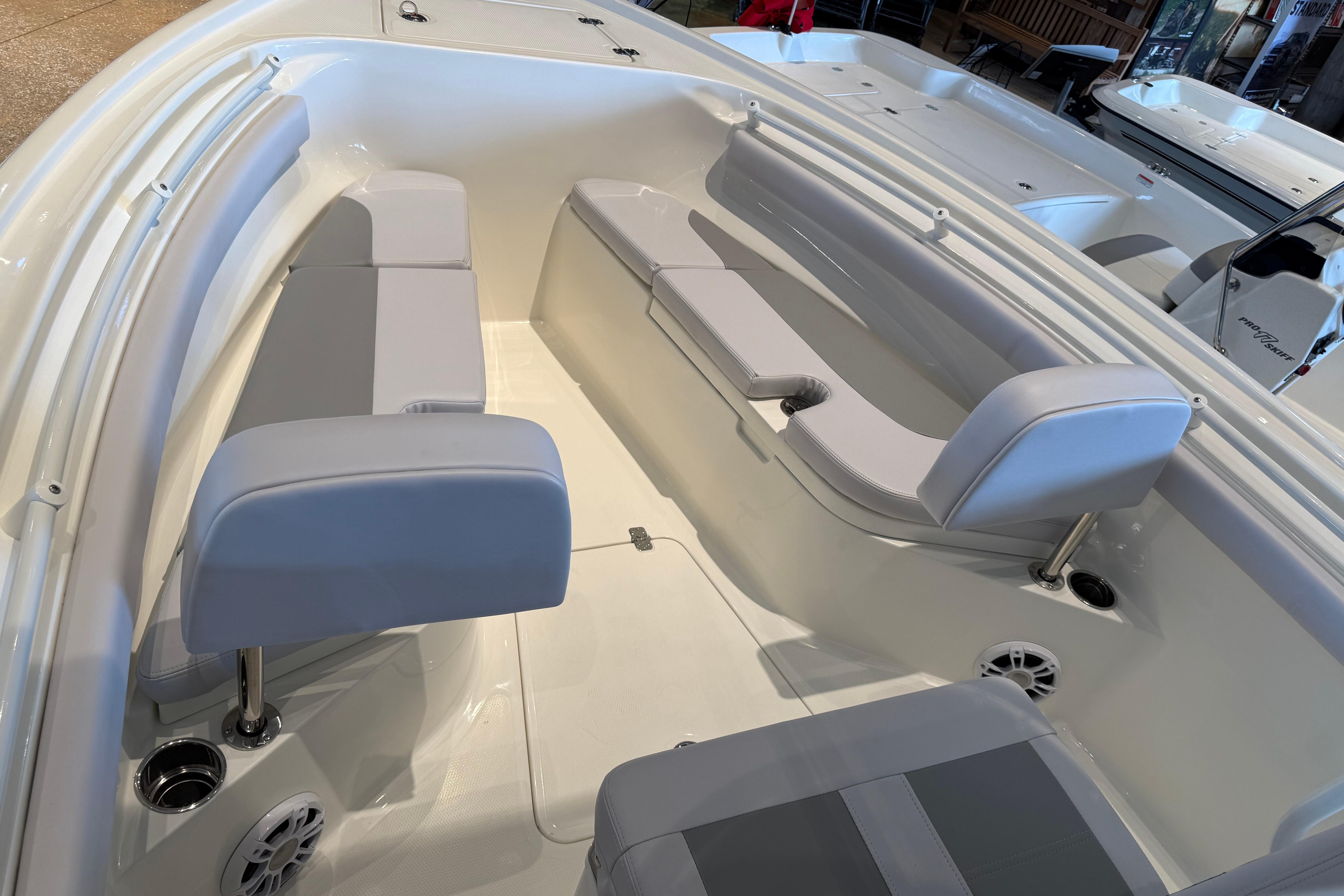 2026 Mako 214 Center Console boat interior with cushioned seating and cup holders.