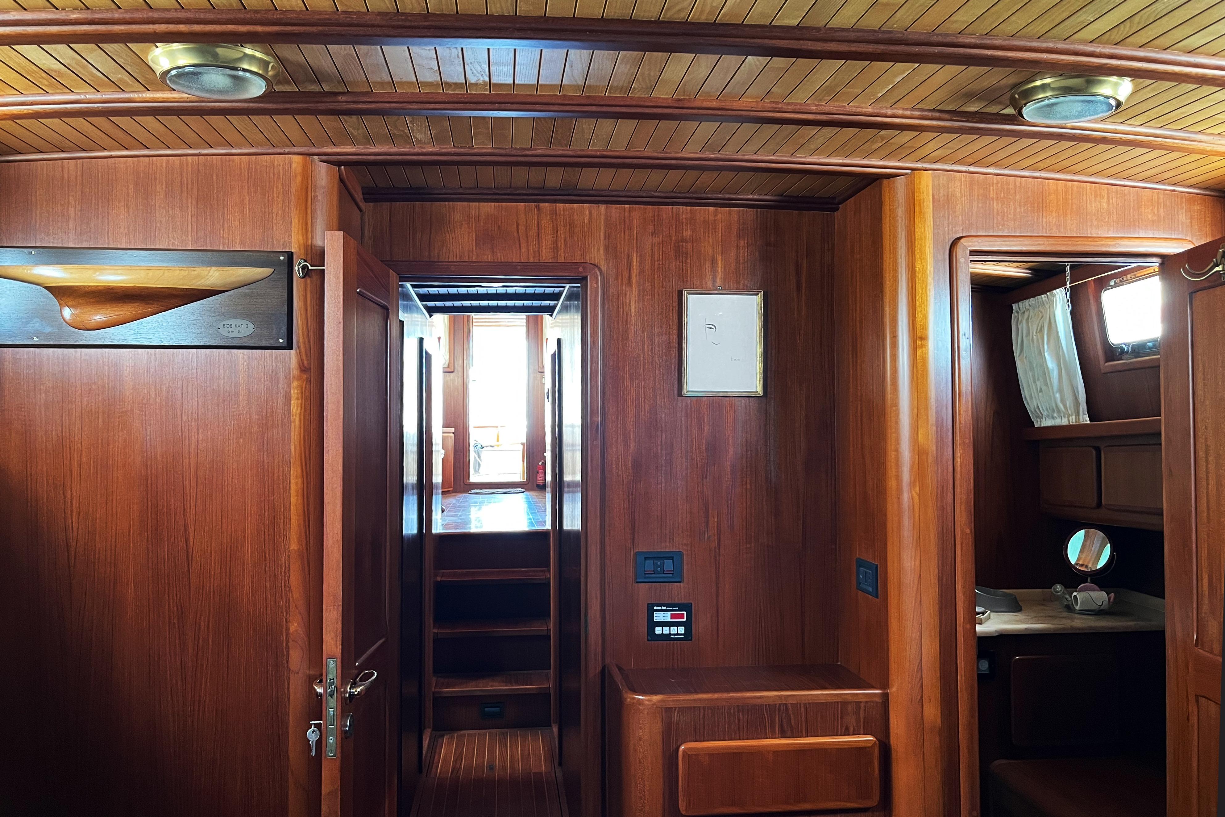 Interior of 1996 Custom Cantiere Azzurro 16 yacht with wooden paneling and cozy cabin.