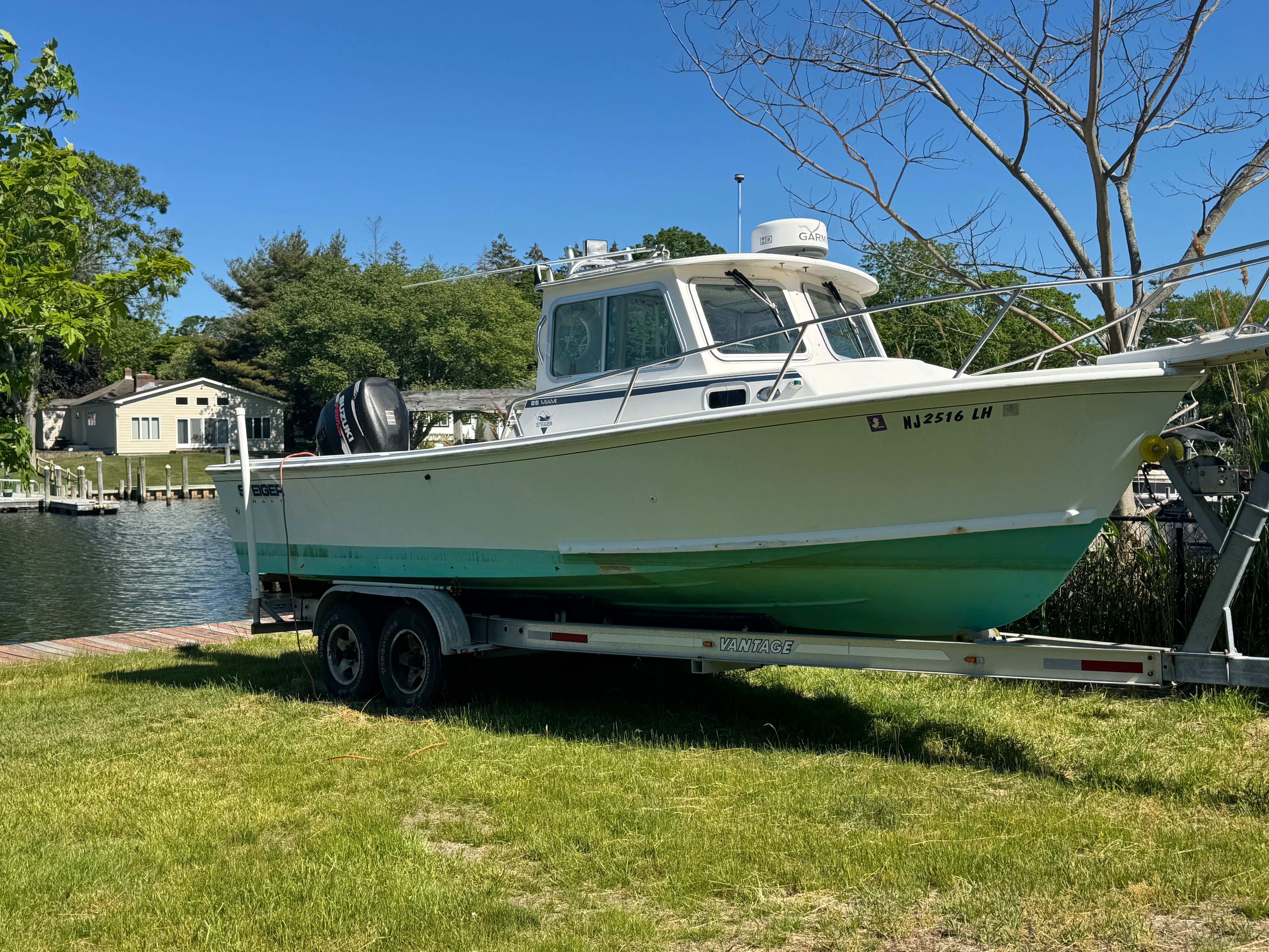 2009 Steiger Craft 25 Miami boat on trailer by the water.
