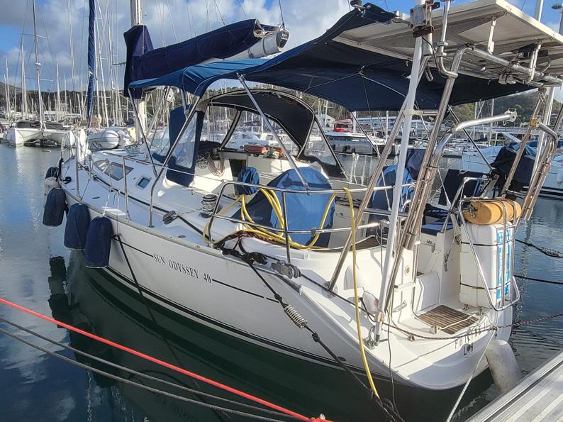 Jeanneau Sun Odyssey 40 sailboat, 2000 model, docked in a marina with blue covers.