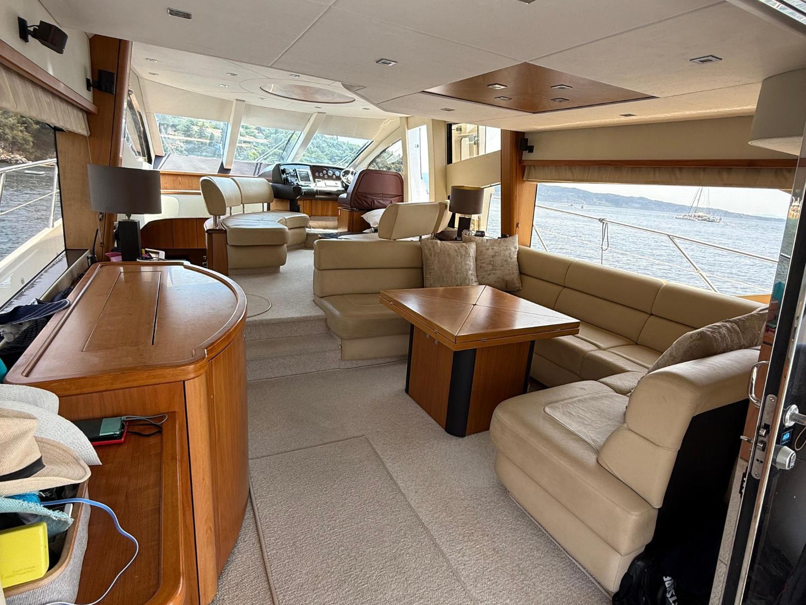 Luxurious interior of 2008 Sunseeker Manhattan 60 yacht with beige seating and wooden accents.