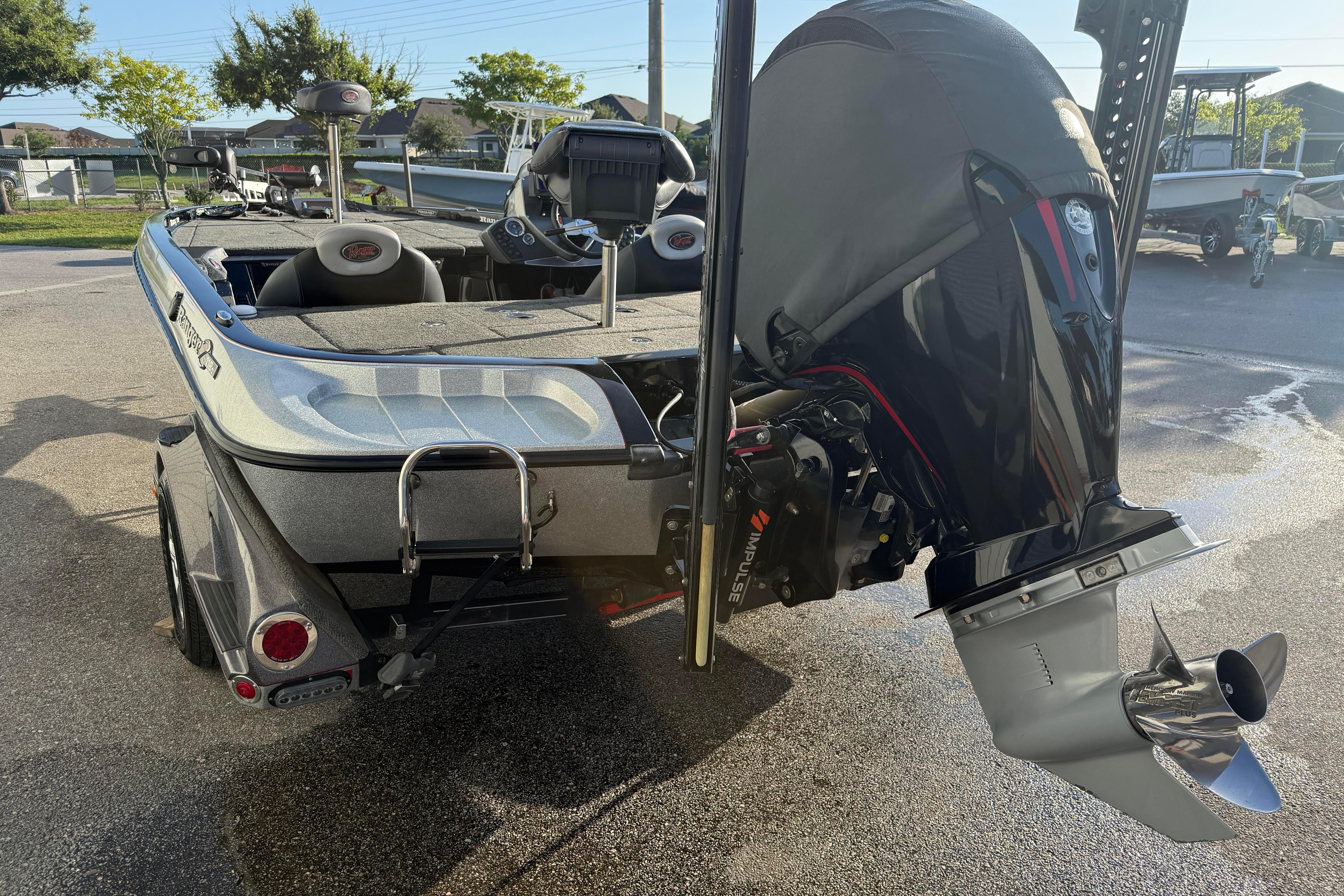 2015 Ranger Z118 Comanche boat with powerful outboard motor in a sunny outdoor setting.