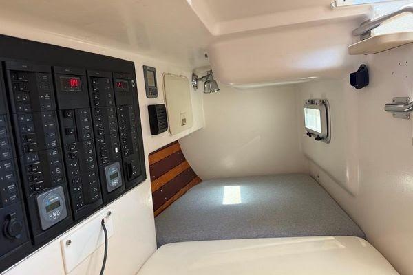 Interior cabin of 2011 Reliance 44 boat with control panels and sleeping area.