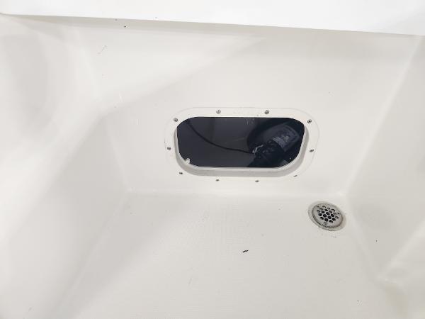 Interior view of 2025 Pathfinder 2400 Open boat, featuring a drain and access hatch.