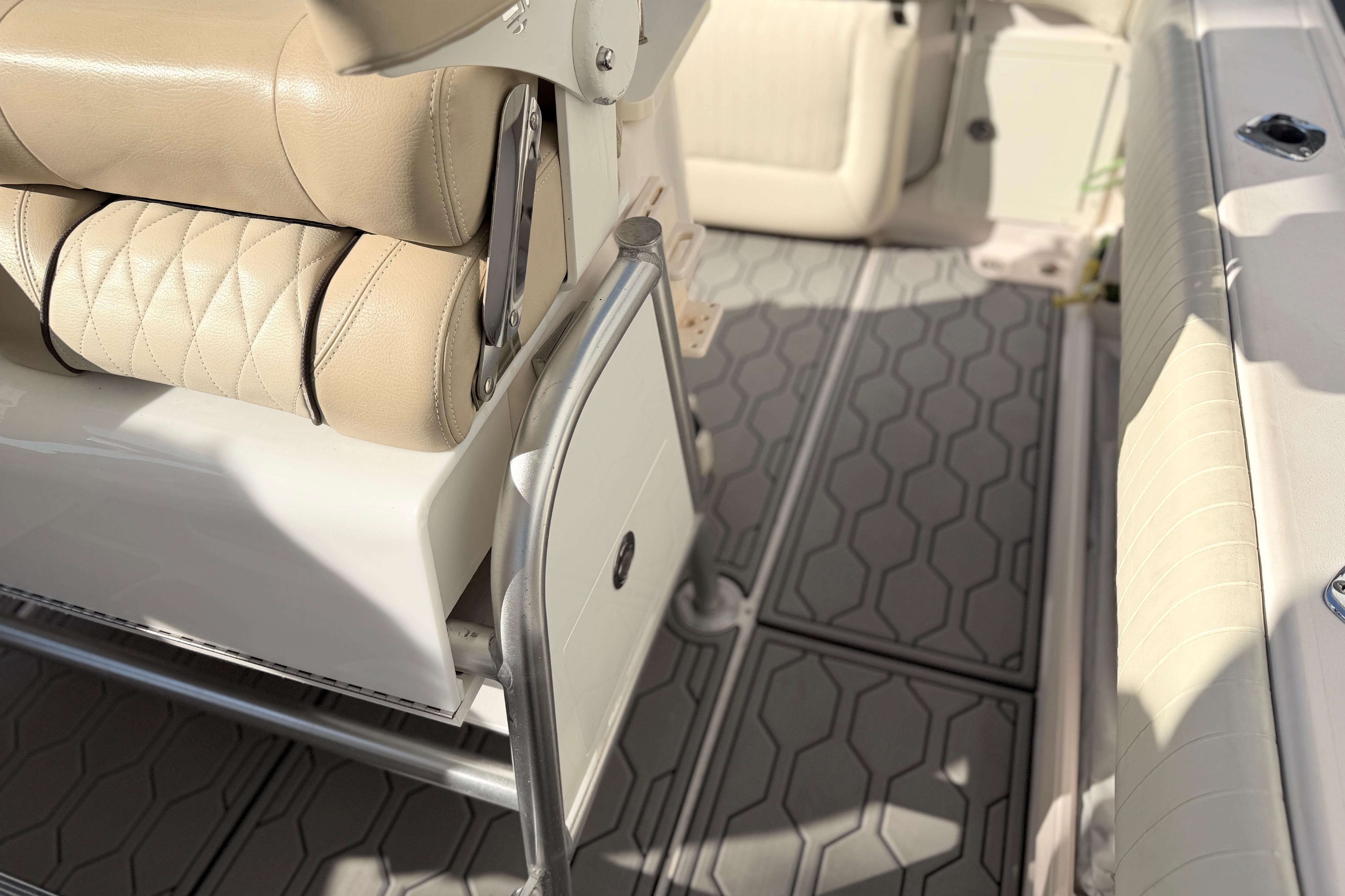 2004 Grady White 273 boat interior with beige seating and textured flooring.