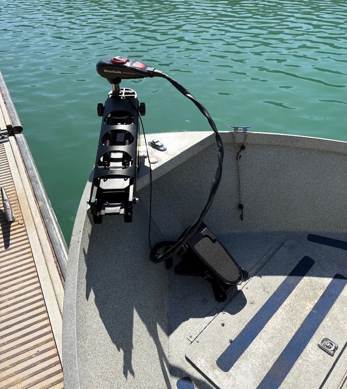 A 2002 Stryker Rogue boat is docked. It features a motor at the bow.