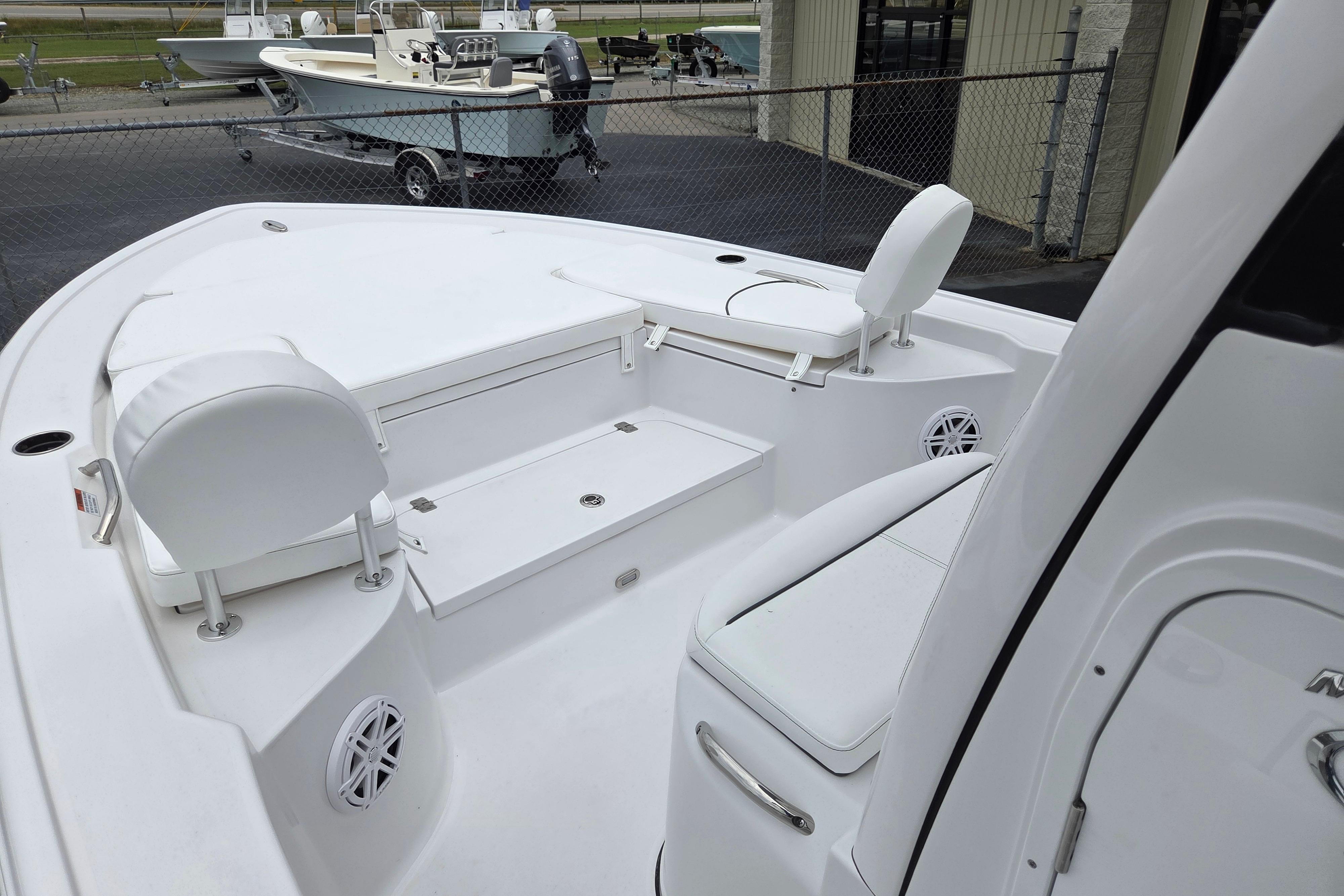 2026 Sportsman Masters 247 Bay Boat interior with white seating and storage compartments.