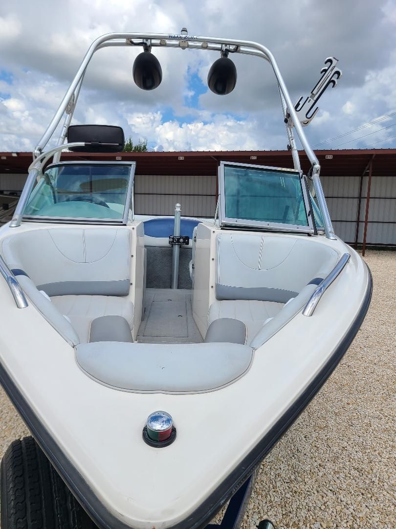 2003 MasterCraft X-9 boat with open bow seating and wakeboard tower.