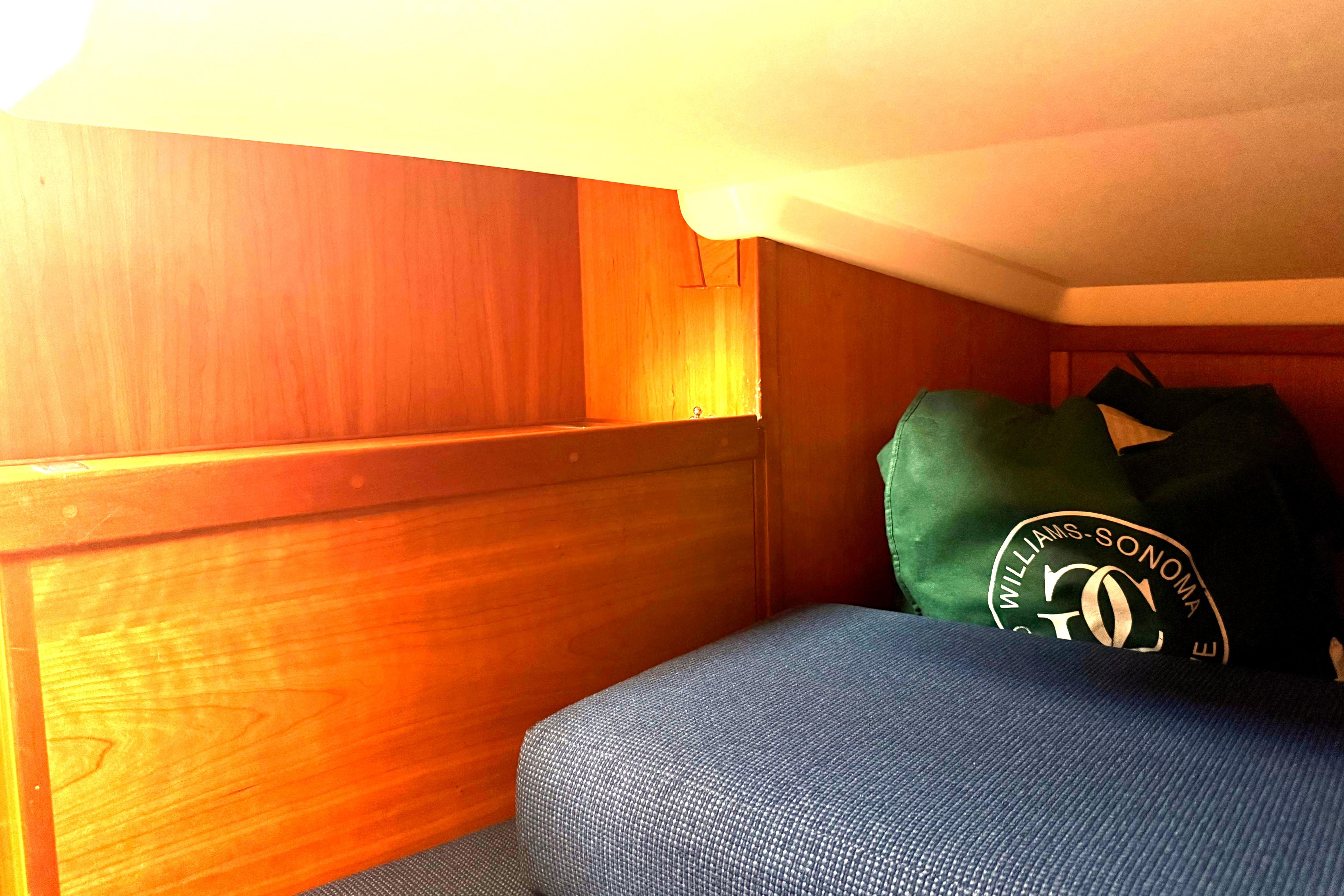 Interior cabin of 2004 Sabre 386 sailboat with wooden paneling and storage bag.