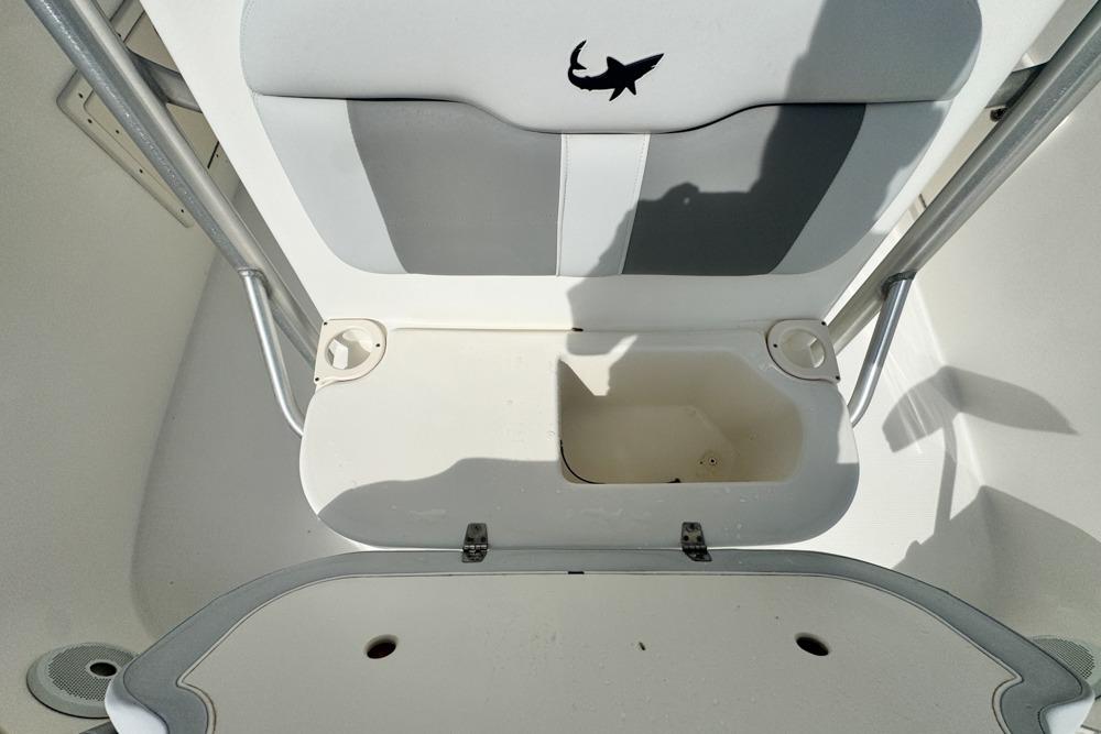 2018 Mako 284 Center Console boat interior with storage compartment open.
