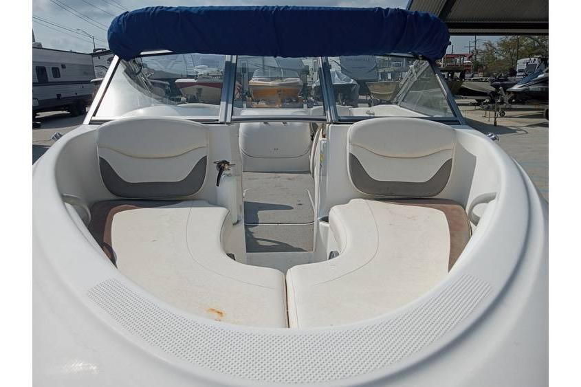 2008 Bayliner 175 boat interior with white seating and blue canopy.