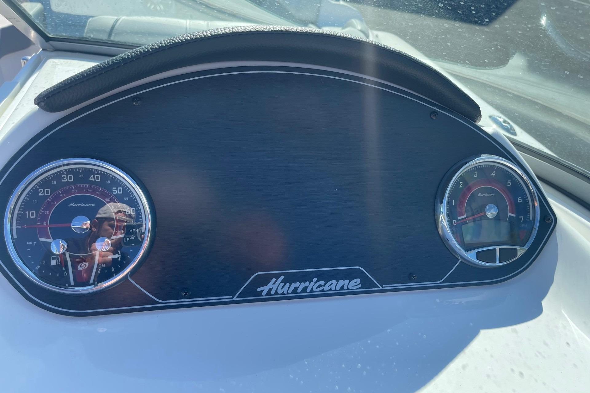 Dashboard of 2023 Hurricane SunDeck 2400 OB boat with speedometer and tachometer.