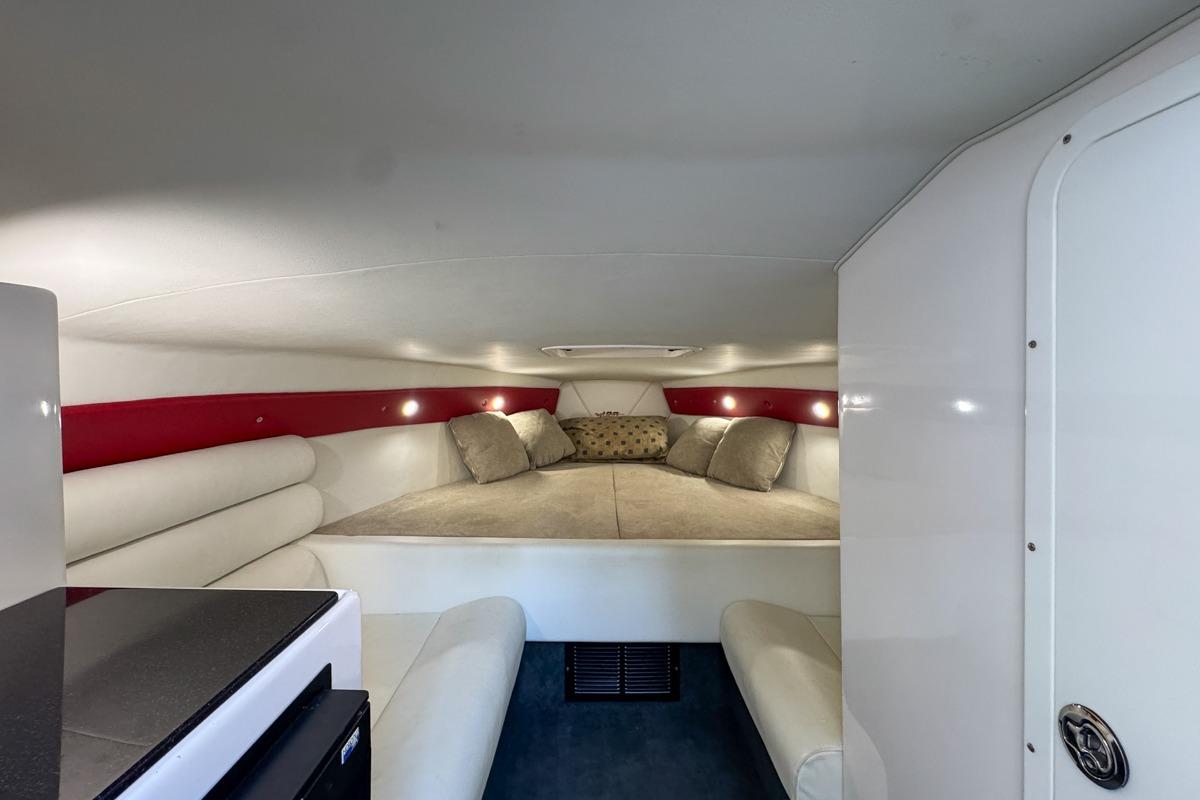 Interior of 2022 Velocity 290sc boat with cozy cabin and seating area.