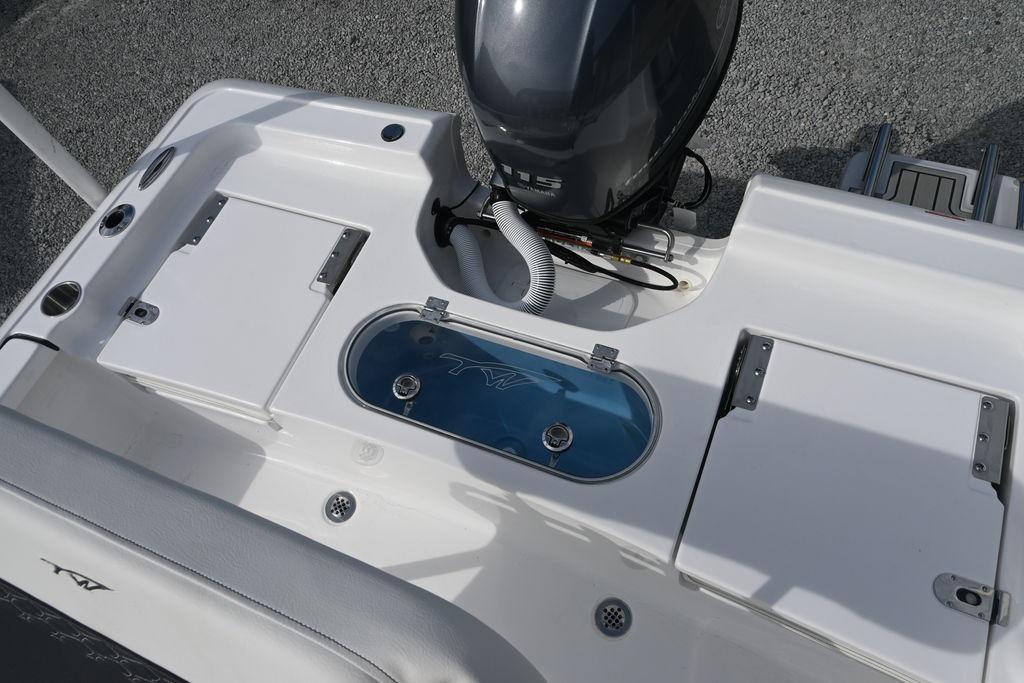 2026 Tidewater 1910 Bay Max boat deck with motor and storage compartments.
