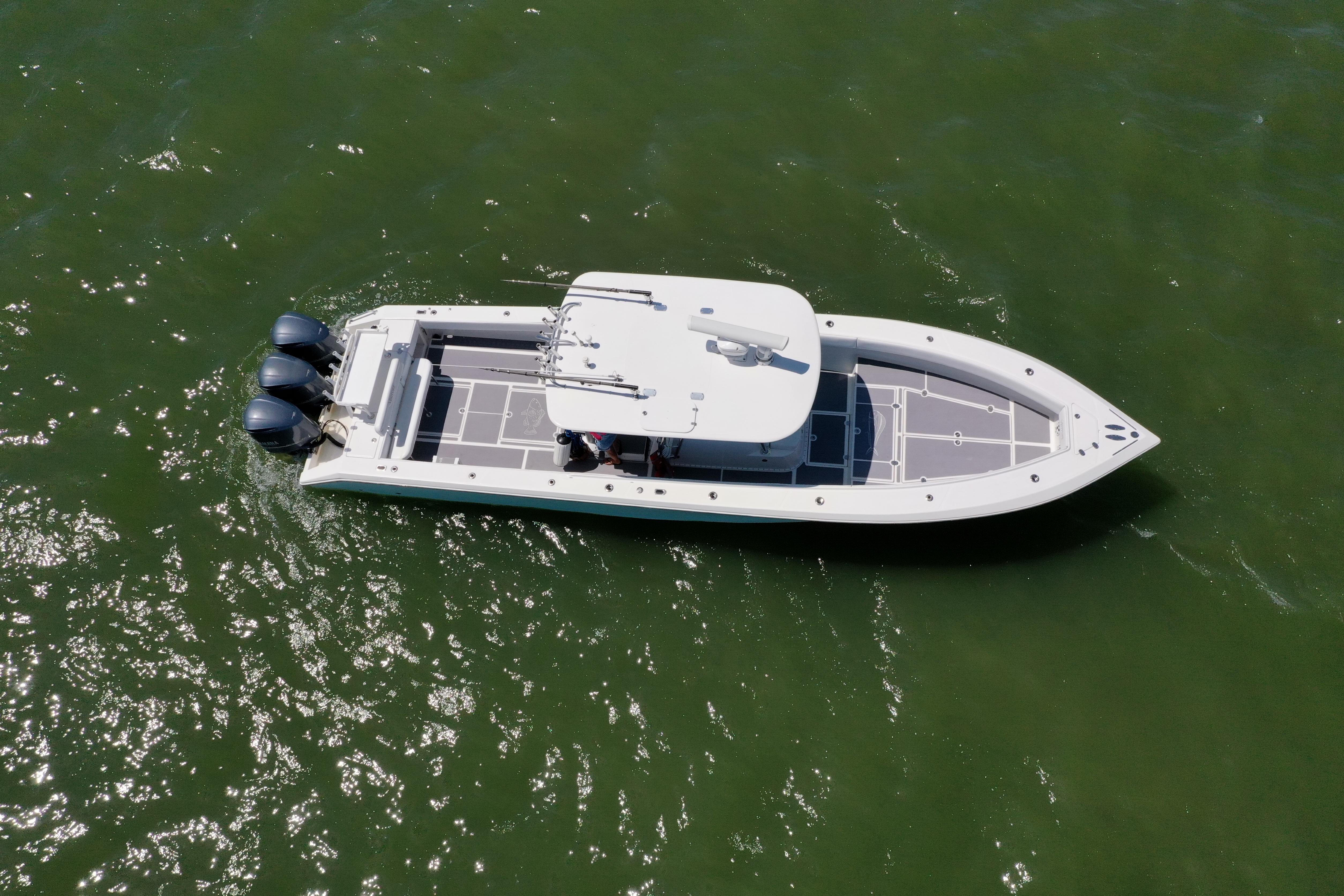 Aerial view of 2009 Venture 39 Center Console boat on green water.