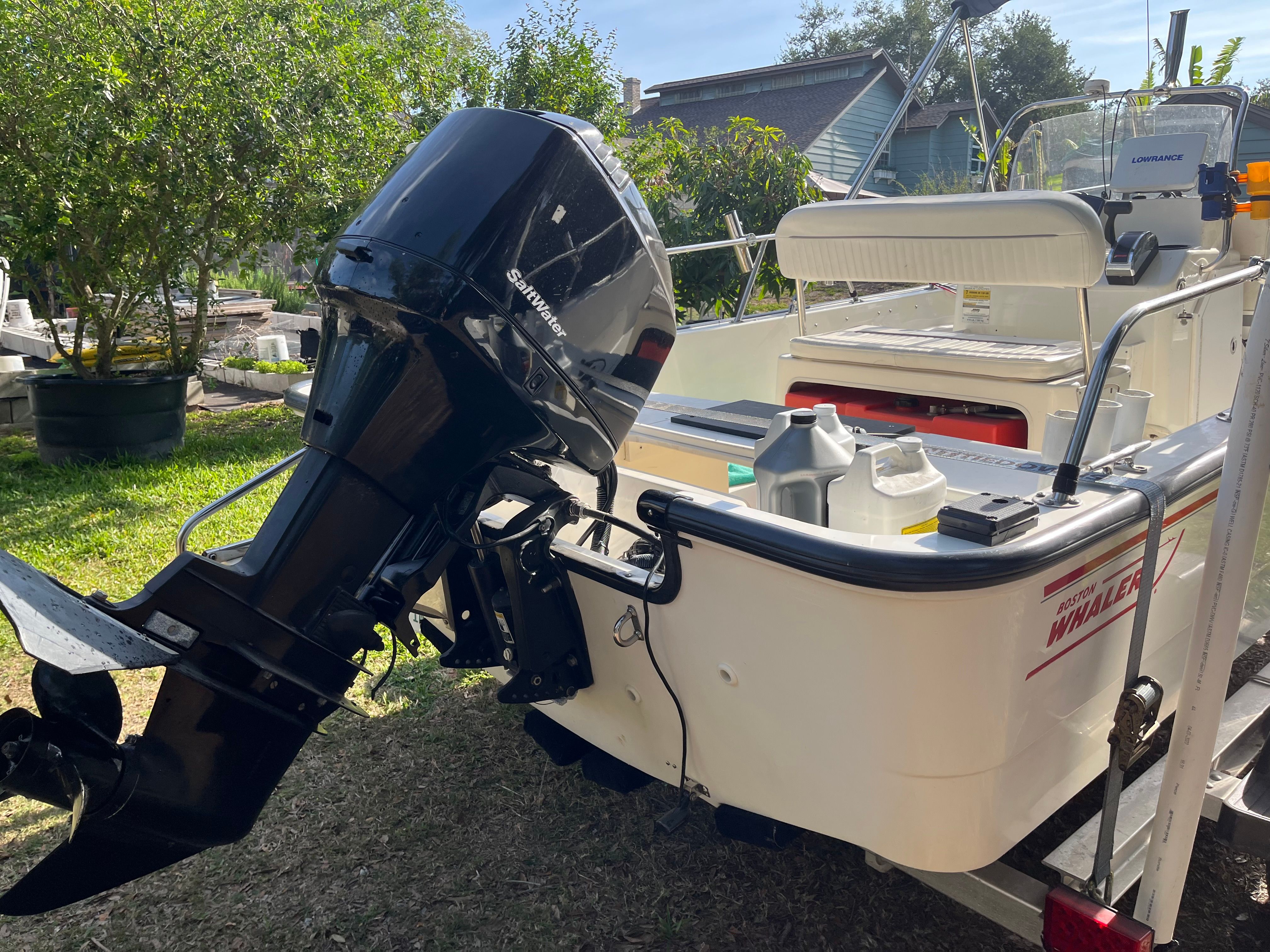 Boston Whaler 170 Montauk 2005 on trailer in garden.