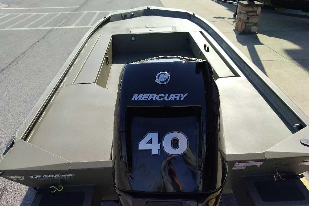 2026 Tracker Grizzly 1654 T Sportsman boat with Mercury 40 engine, parked outdoors.