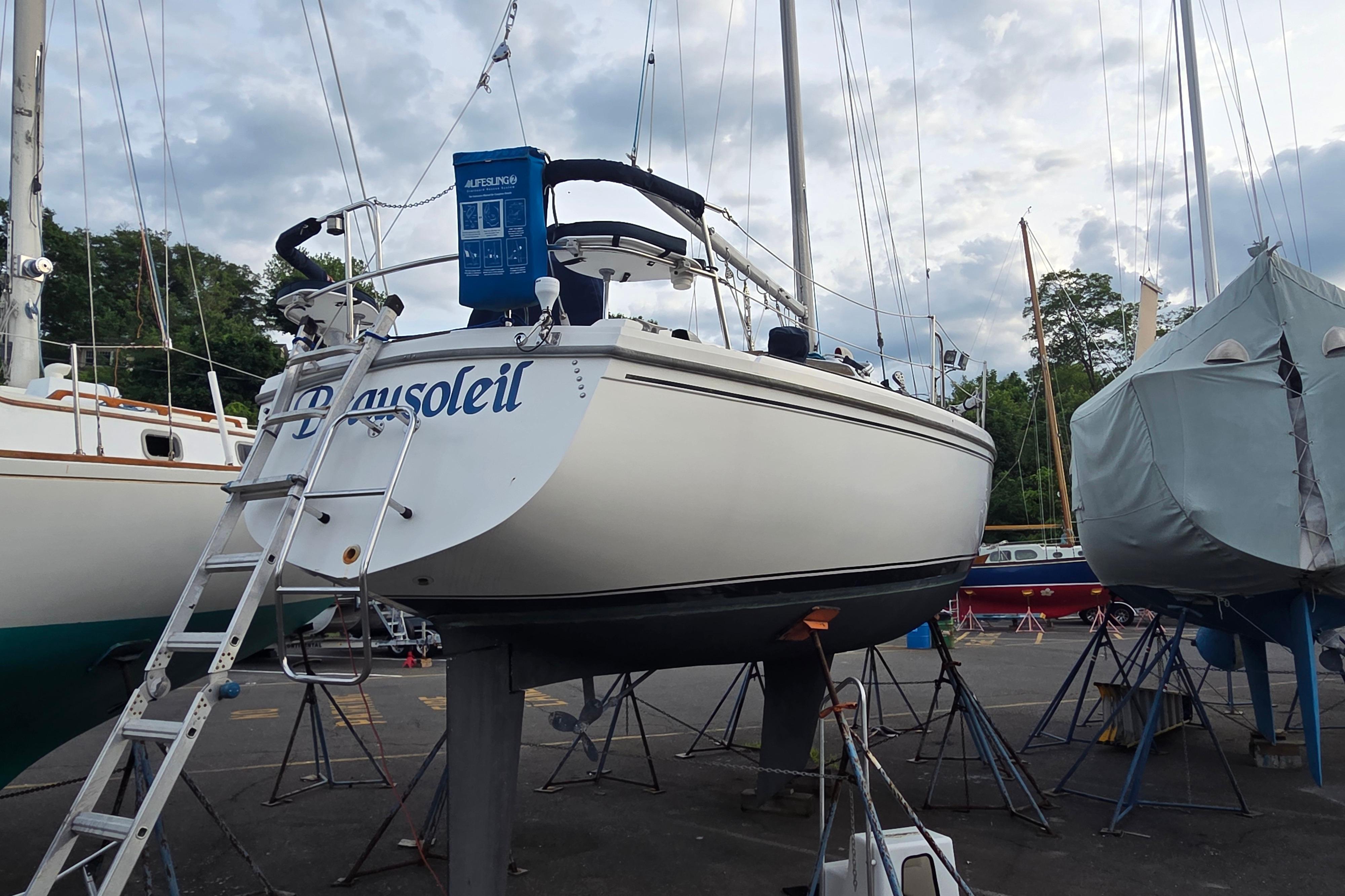 Catalina 355 sailboat from 1986 on dry dock, surrounded by other boats and equipment.