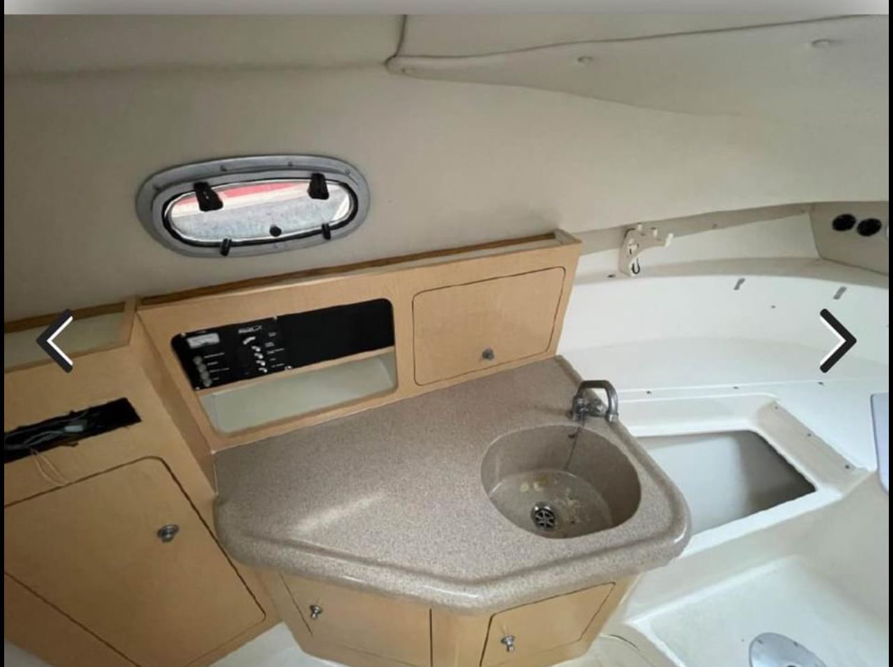 Interior of 2001 Boston Whaler 26 Conquest with sink and storage.