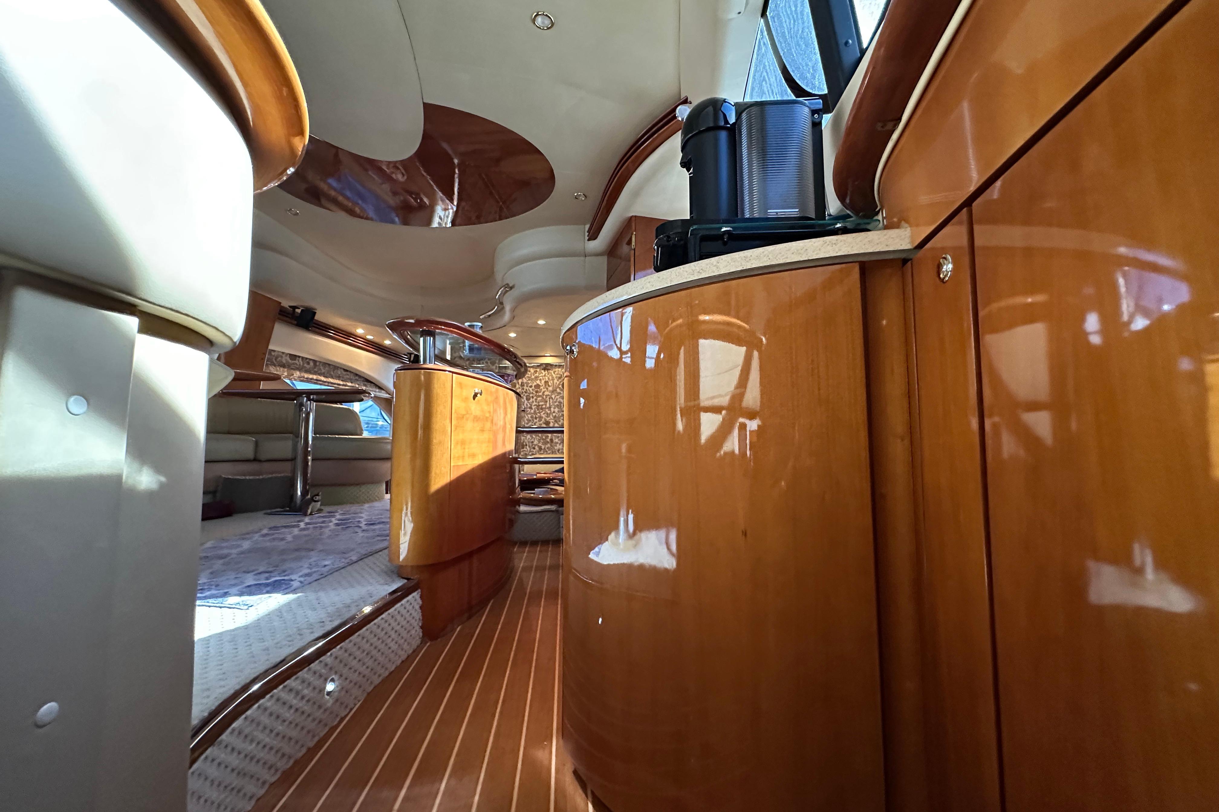 Luxurious interior of a 2004 Azimut 55E yacht with polished wood finishes.