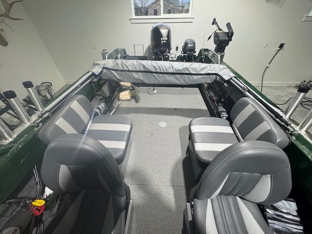 Interior view of a 2023 Hewescraft 180 Sportsman boat with gray seats.
