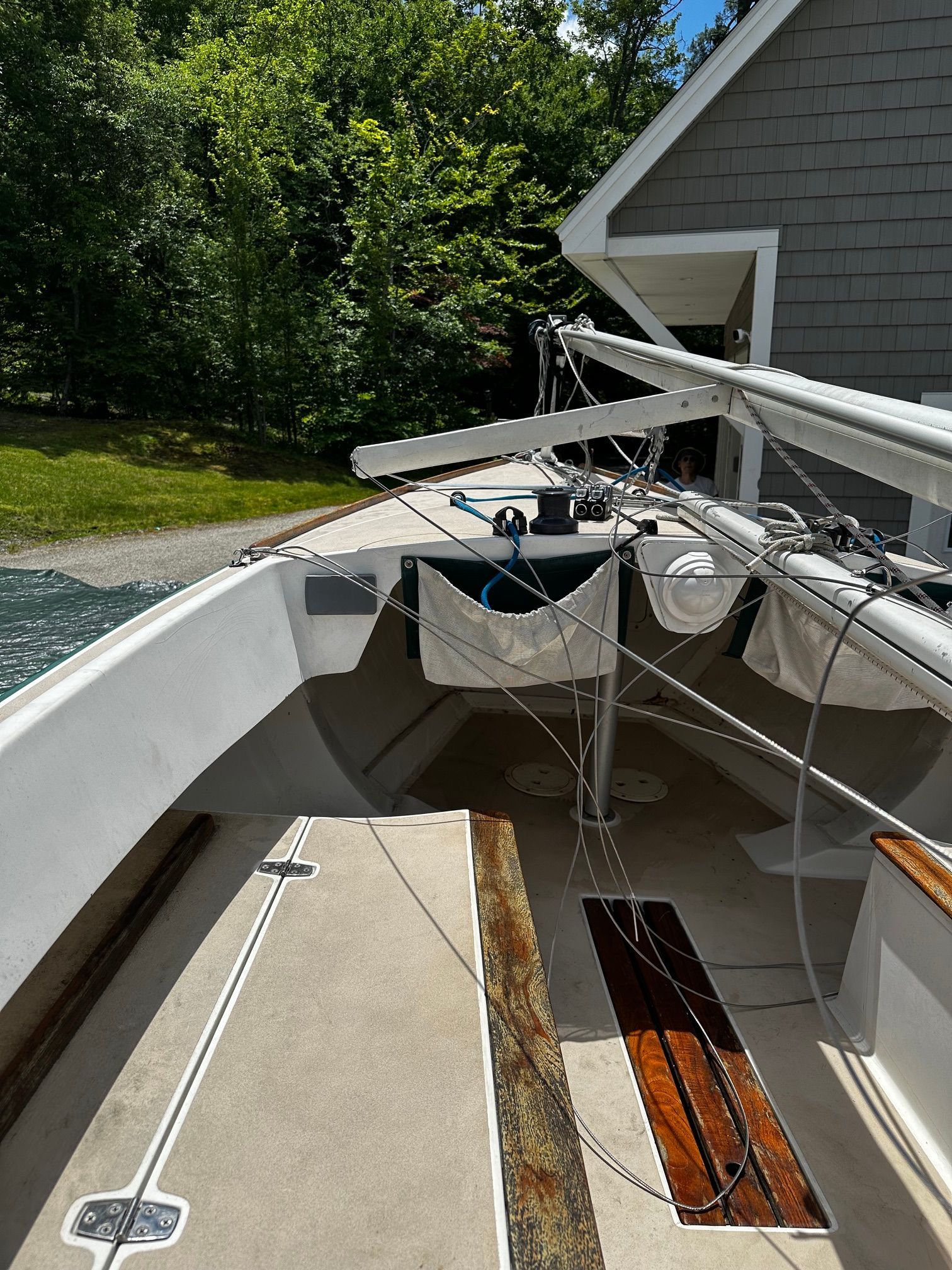 The deck of a 1997 Alerion Express 20 with wood accents and sailing equipment.