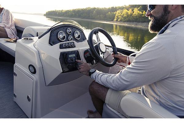 Manufacturer Provided Image: Man steering 2025 Lowe SS 230 WV boat on a serene lake.