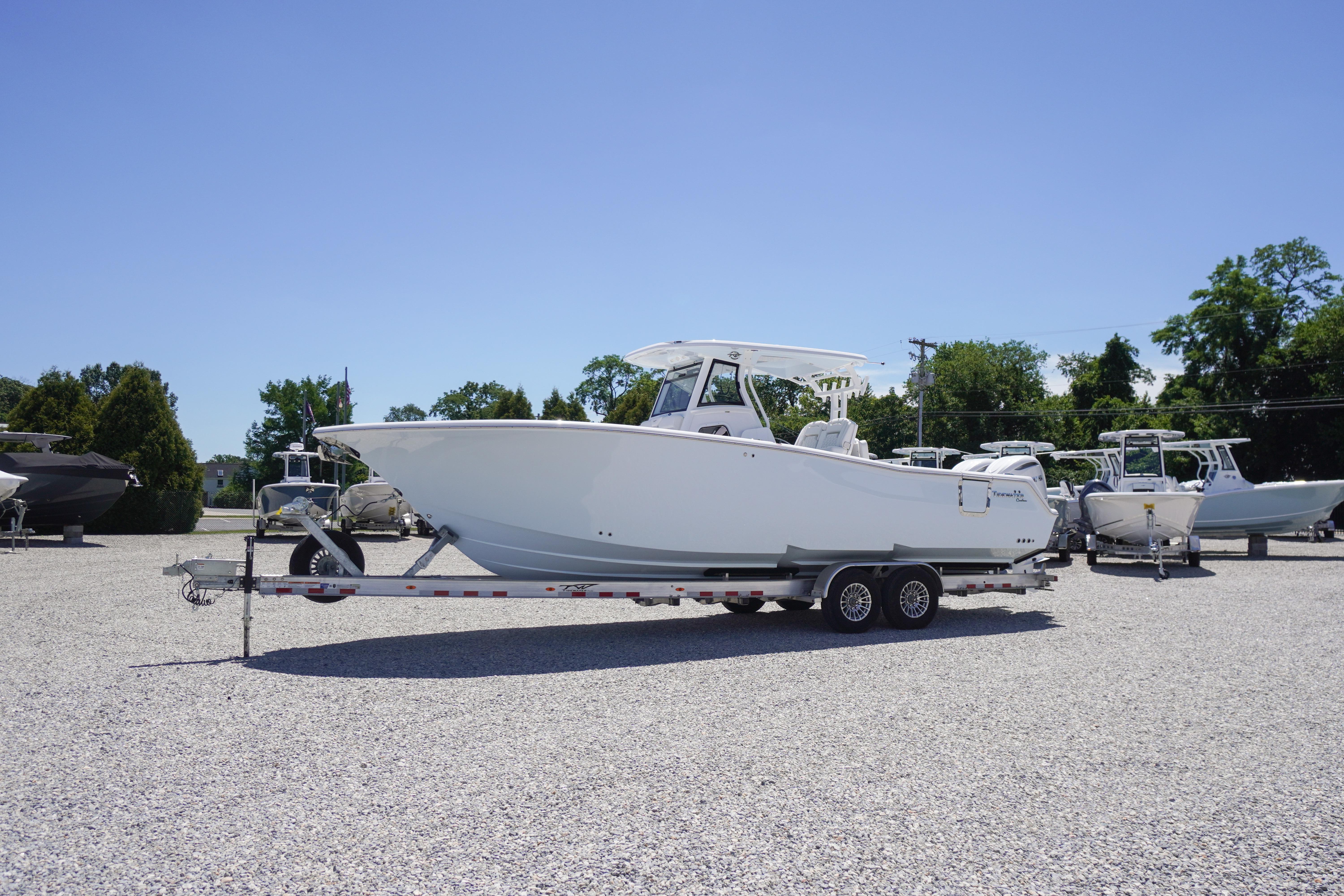 2026 Tidewater 302 CC Adventure boat on trailer in sunny outdoor setting.