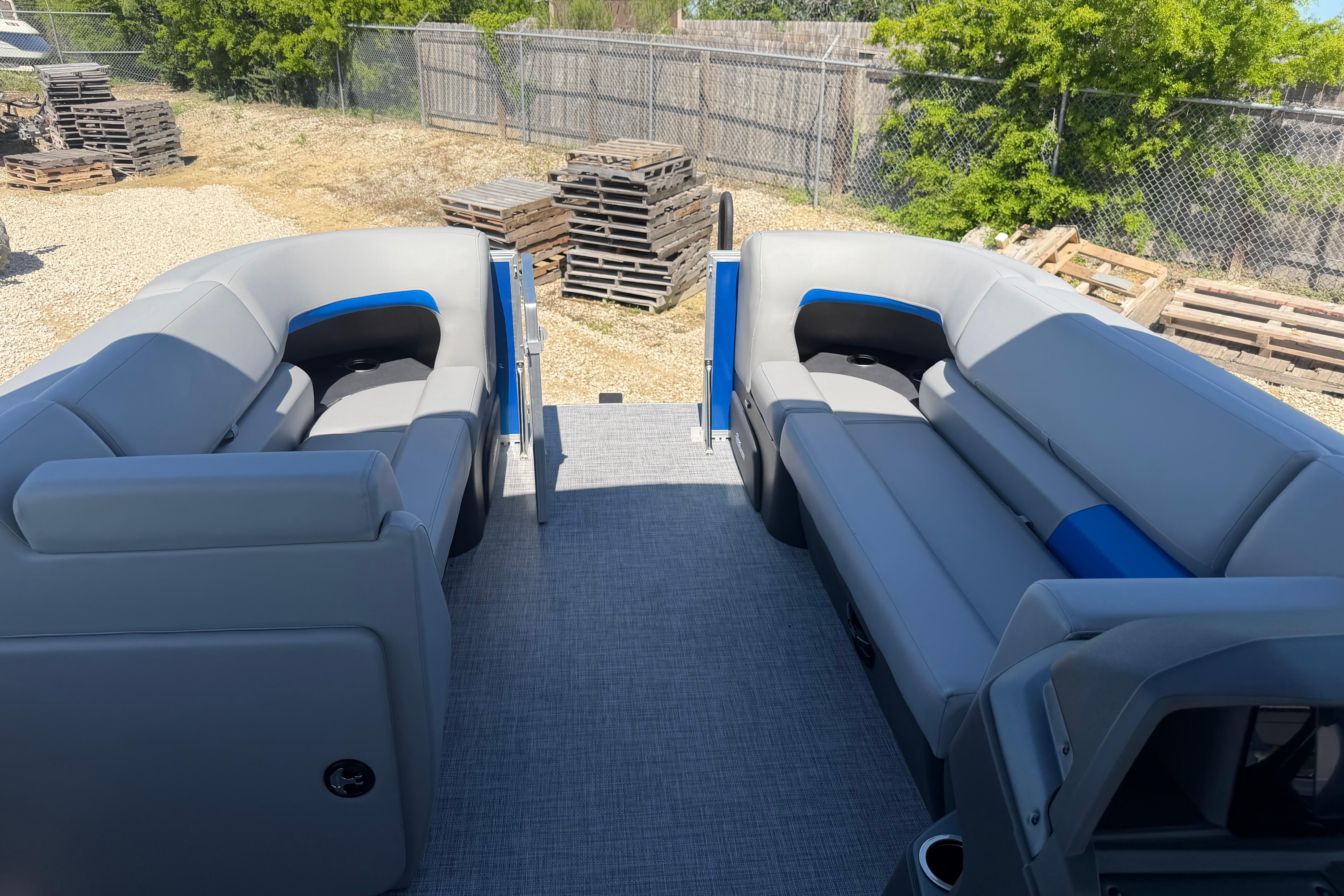 2026 Sun Tracker Party Barge 20 DLX interior with gray seating and blue accents.