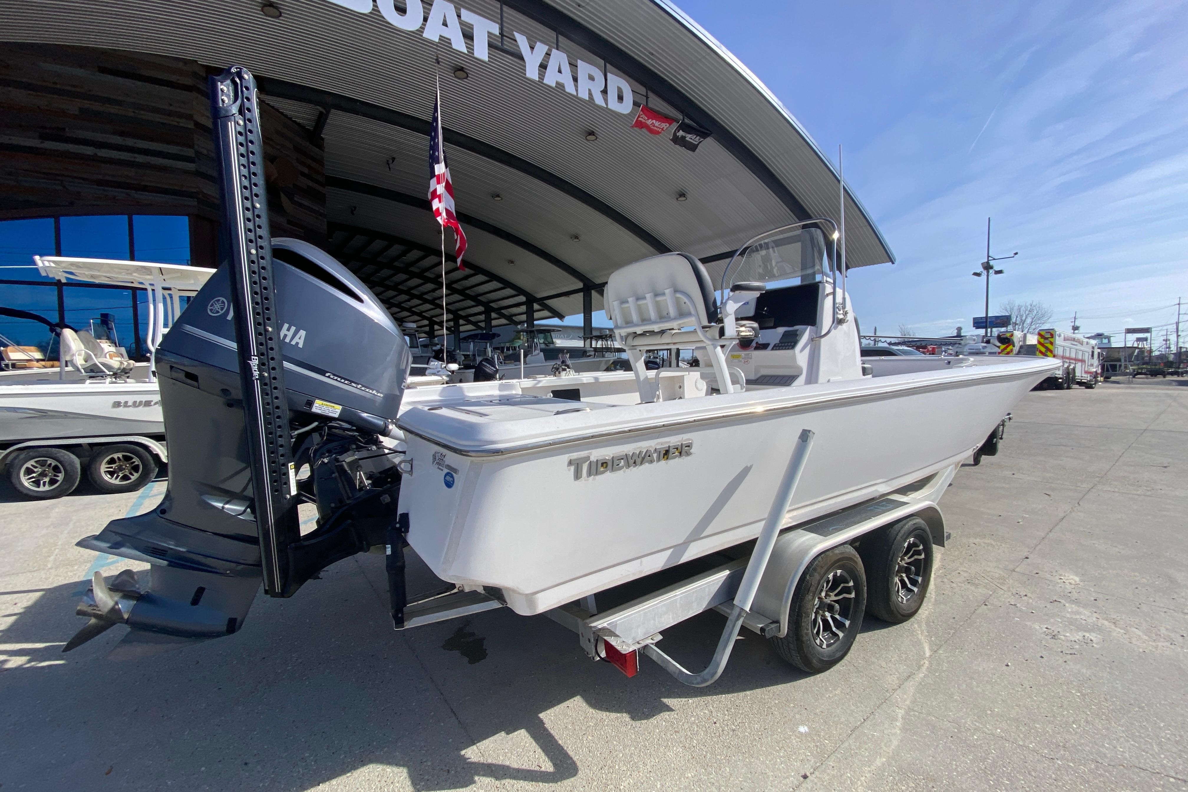 2023 Tidewater 2410 Bay Max boat on trailer at dealership, featuring Yamaha outboard motor.
