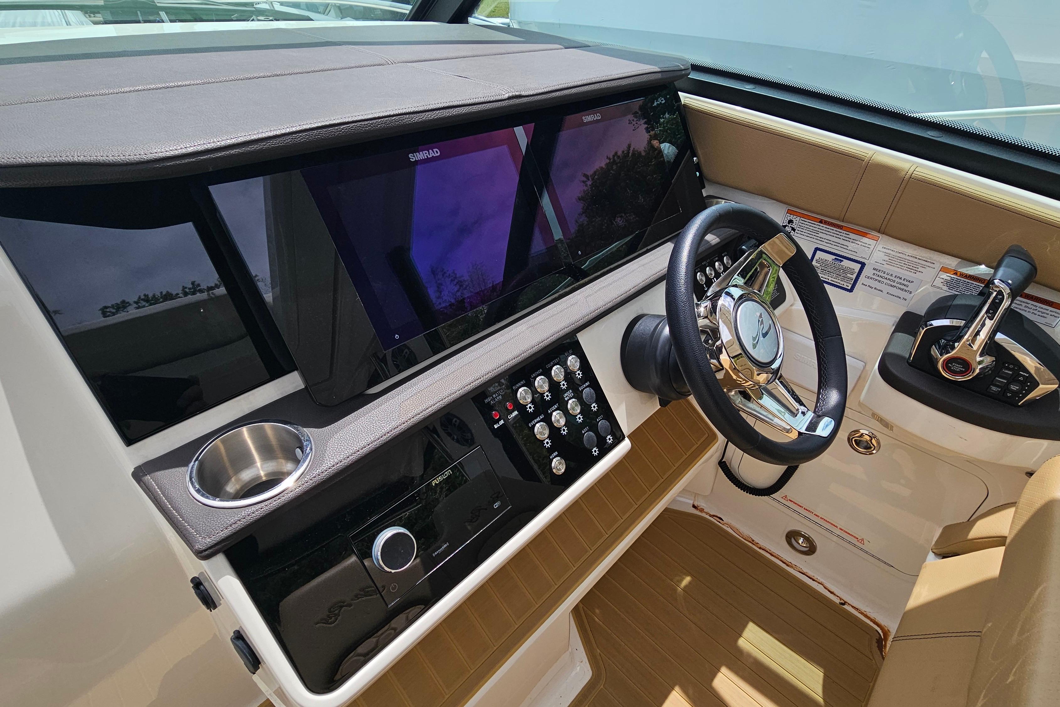 2023 Sea Ray Sundancer 320 helm with modern controls and sleek steering wheel.