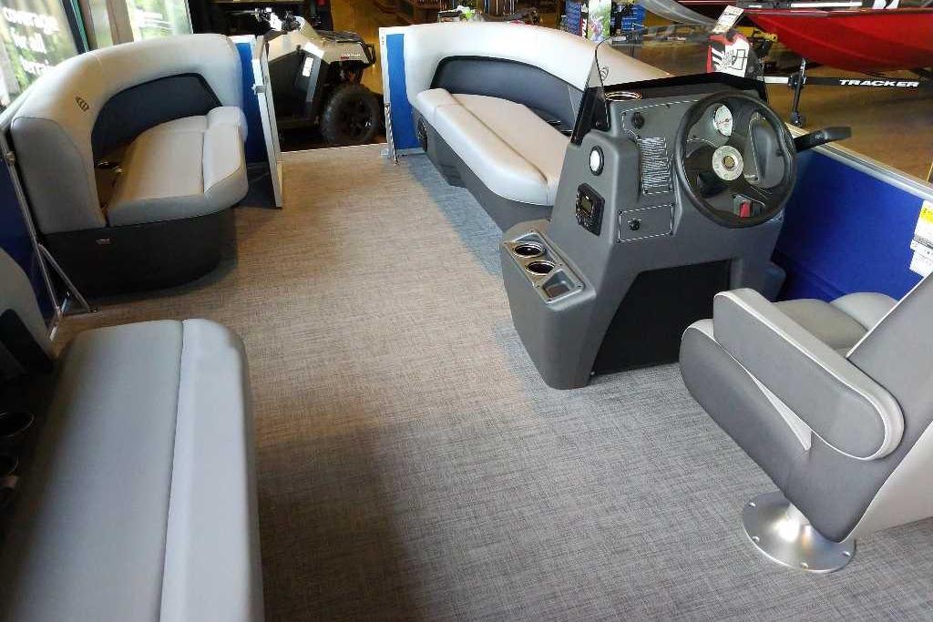 2026 Sun Tracker Party Barge 16 DLX interior with plush seating and modern helm.